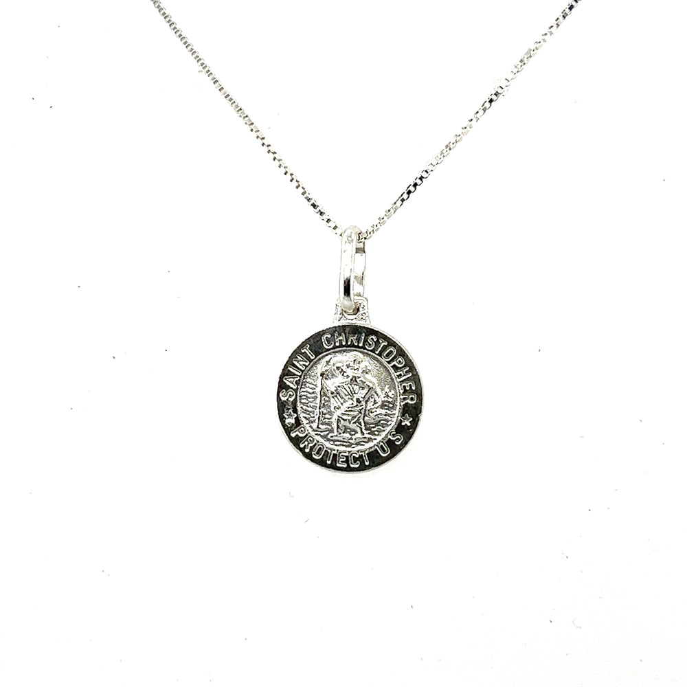 
                  
                    A Super Silver necklace with a small Saint Christopher Medallion In Various Sizes, featuring Saint Christopher, the patron saint of travelers.
                  
                