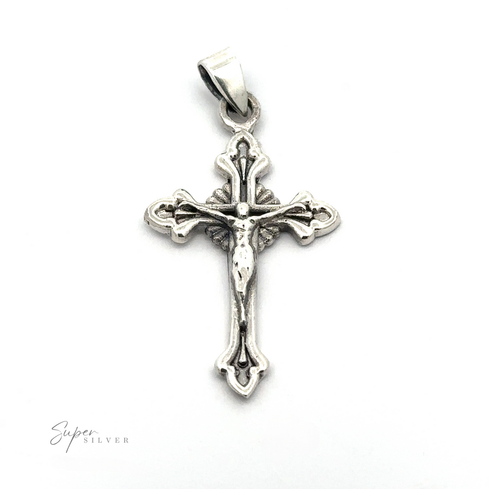 
                  
                    A vintage Crucifix Charm featuring a detailed figure of Jesus crucified, with ornate designs on the sterling silver crucifix, mounted on a polished bail.
                  
                