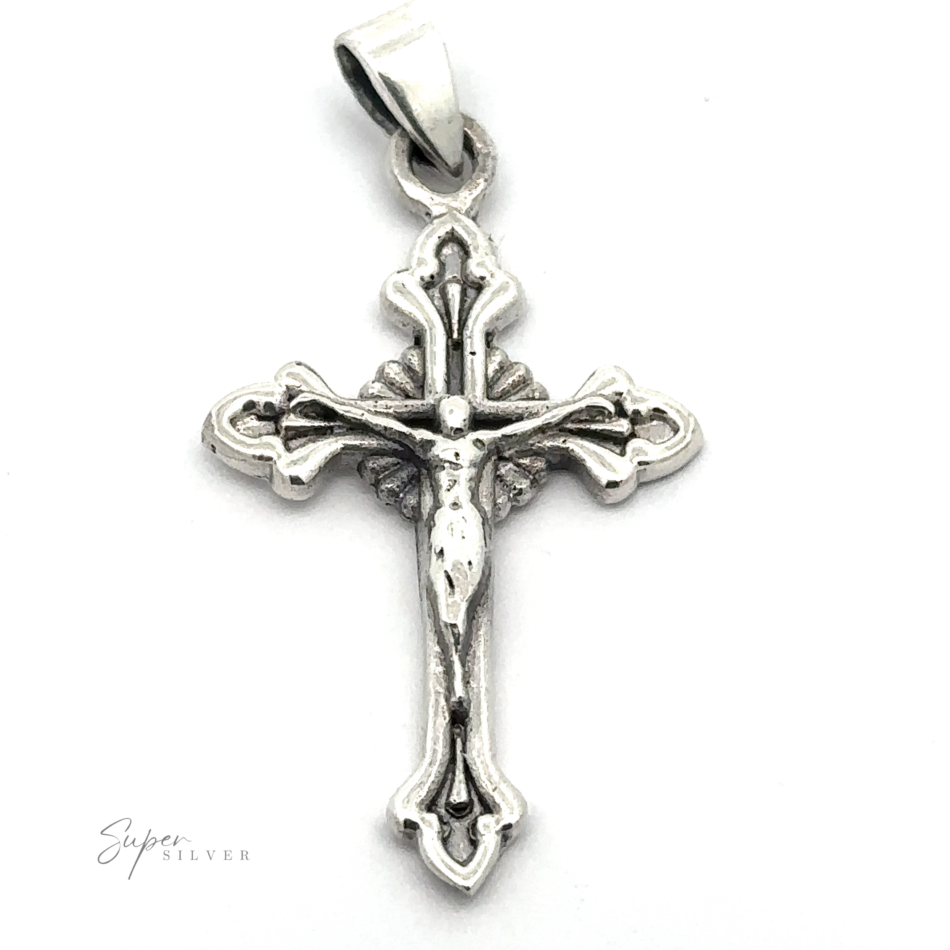 This ornate Crucifix Charm in sterling silver showcases an intricate design, featuring a depiction of Jesus Christ crucified on the cross. The vintage cross pendant includes a loop at the top for easy attachment to a chain.