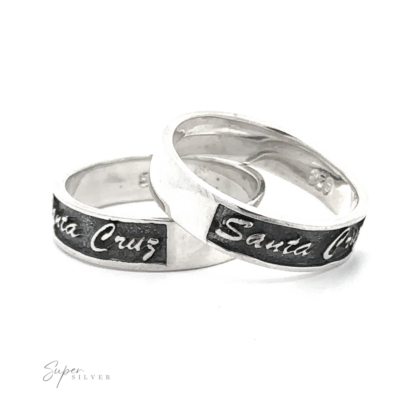 Two flat band Sterling Silver Santa Cruz rings engraved with "Santa Cruz" on a white background.
