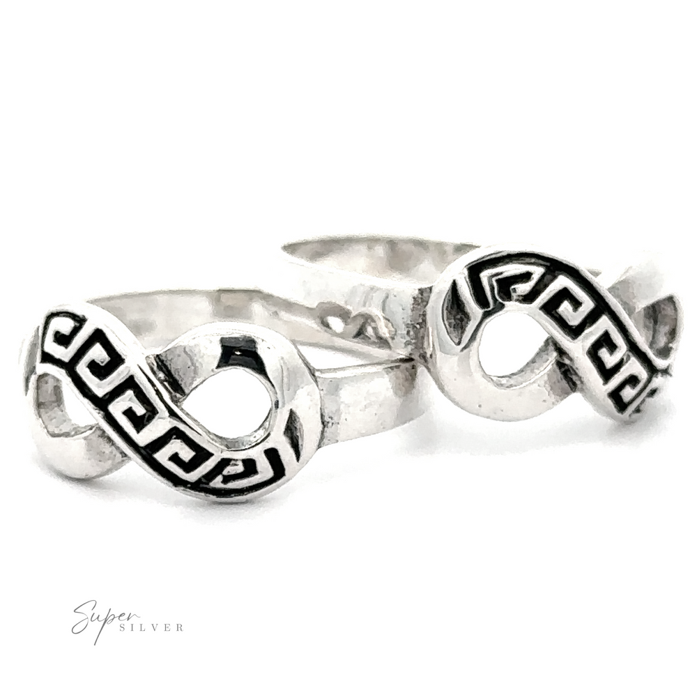 Two Infinity Rings with Greek Key Design. A subtle Greek Key design complements the infinity symbol. The logo "Super Silver" is visible in the bottom left corner.