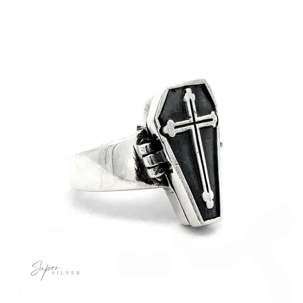 
                  
                    The Poison Coffin Ring with Cross, crafted from .925 sterling silver, showcases a coffin-shaped design with a cross on its face, exuding gothic elegance. Displayed on a white background, this piece is reminiscent of a Gothic Coffin Poison Ring.
                  
                