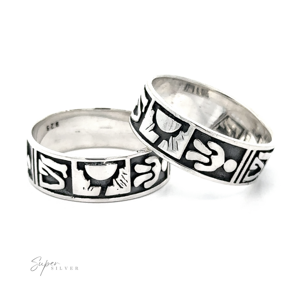 
                  
                    Two Petroglyph Silver Bands with tribal patterns reminiscent of ancient rock carvings on a white background.
                  
                
