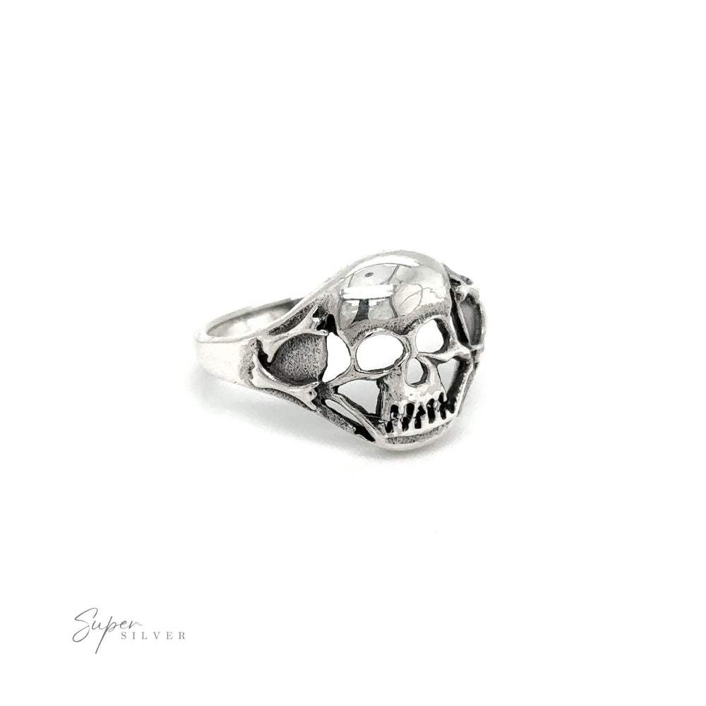 
                  
                    A gothic sterling silver smaller skull ring glimmers against a crisp white background.
                  
                