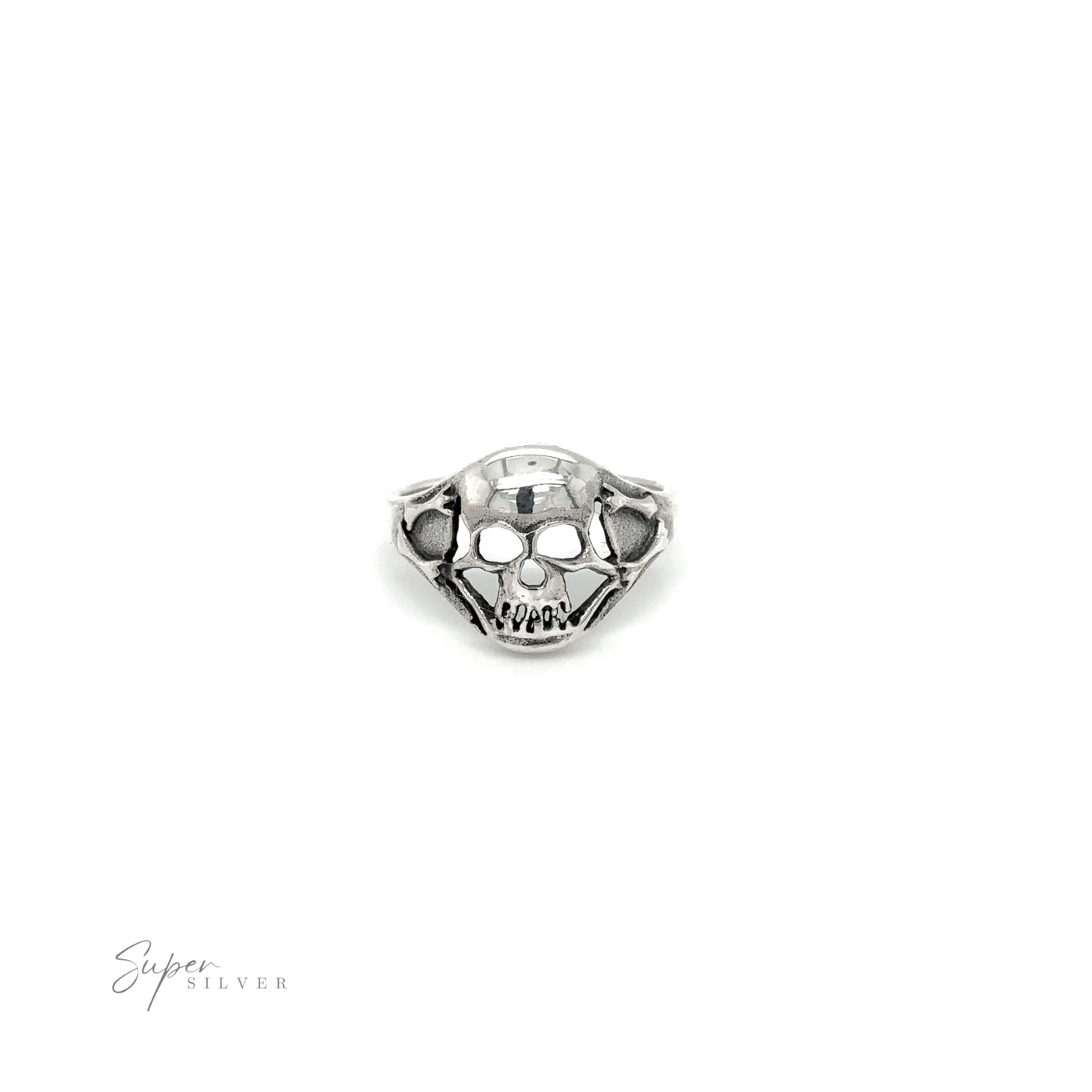 A gothic silver smaller skull ring on a white background.
