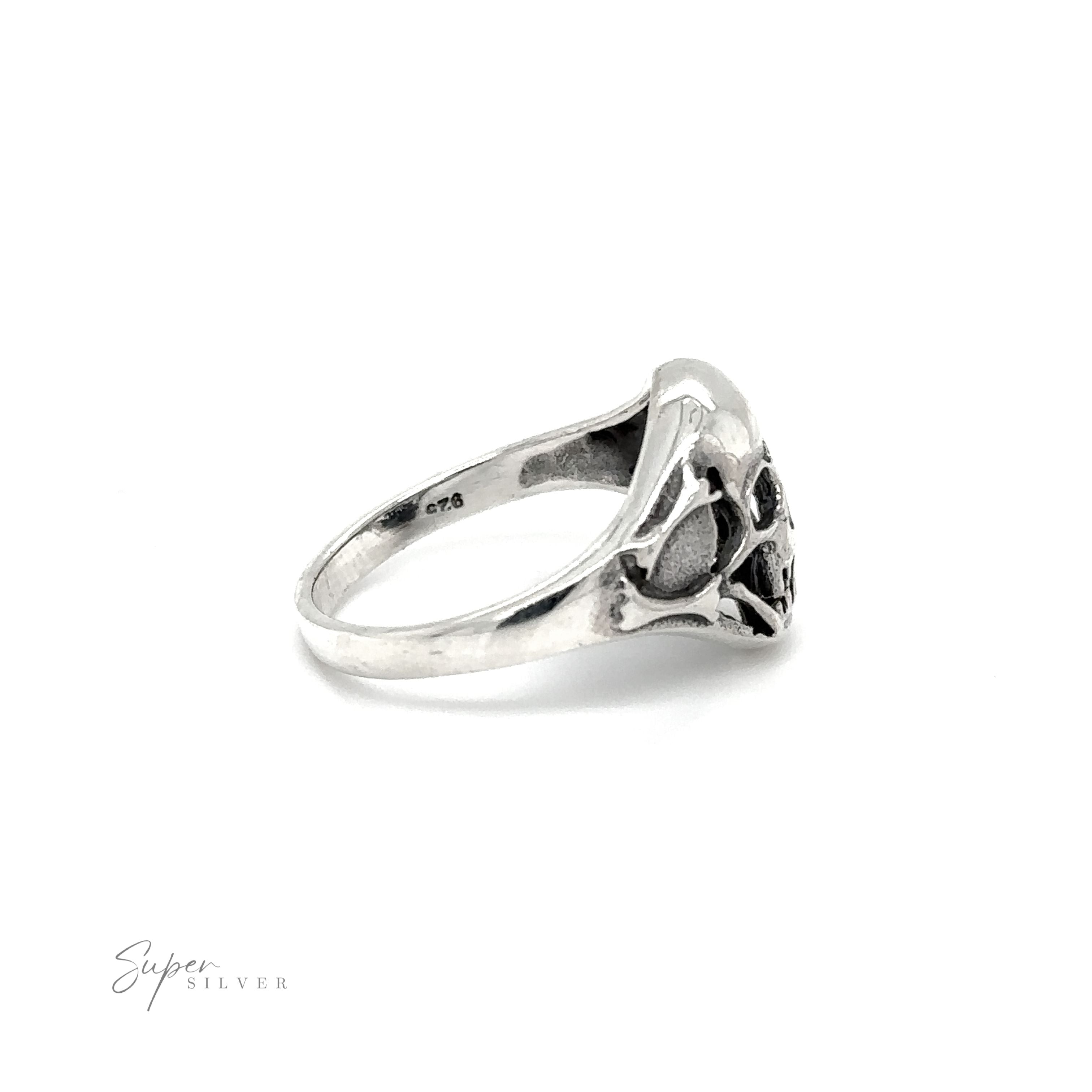 A gothic smaller skull ring on a white background.