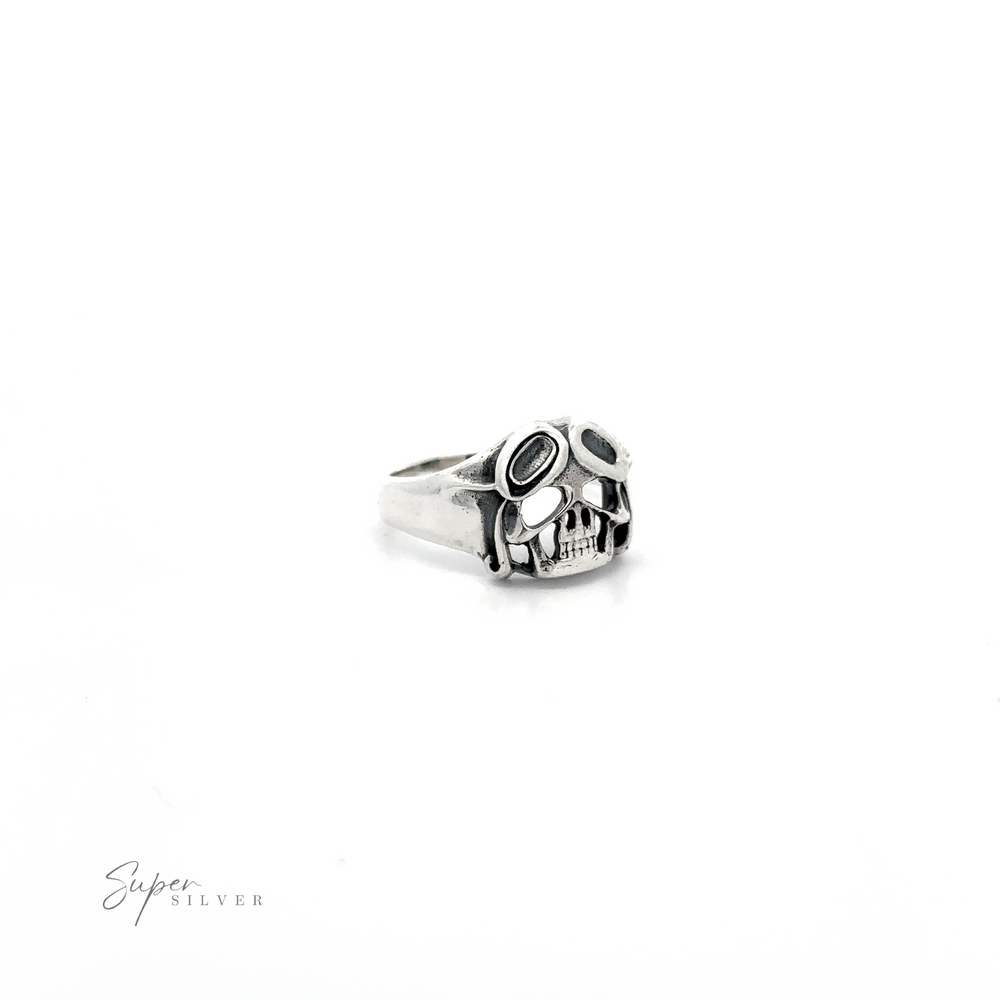 
                  
                    A Aviator Silver Skull Ring with black detailing, isolated on a white background.
                  
                