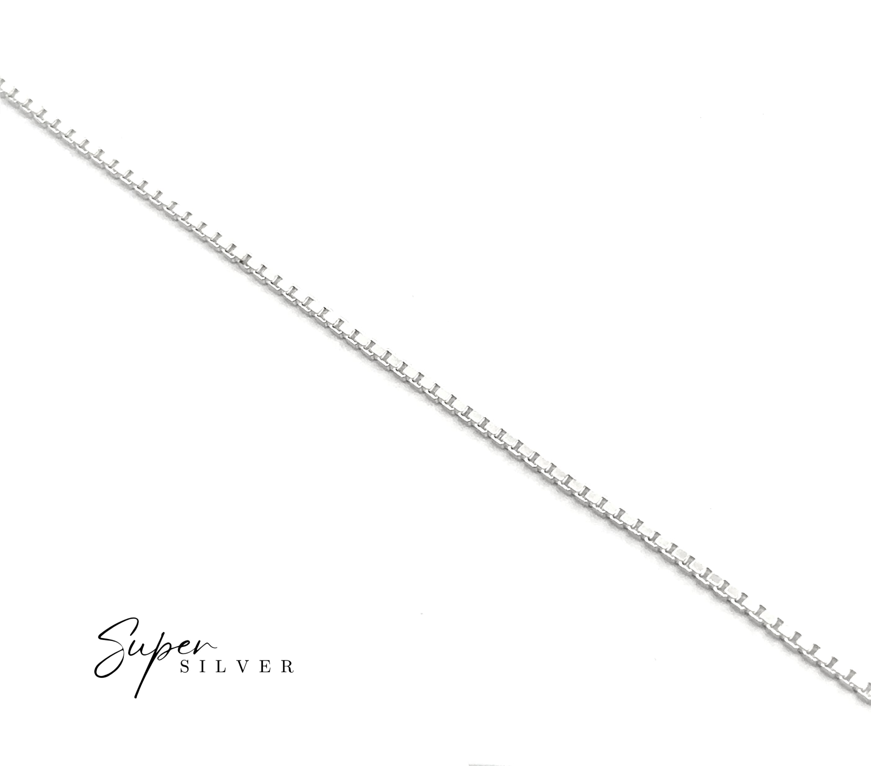 The Italian Edge Box Chain, a thin sterling silver necklace, is arranged diagonally on a white background with the "Super Silver" logo in the bottom left. Perfect as a minimalist men's necklace.