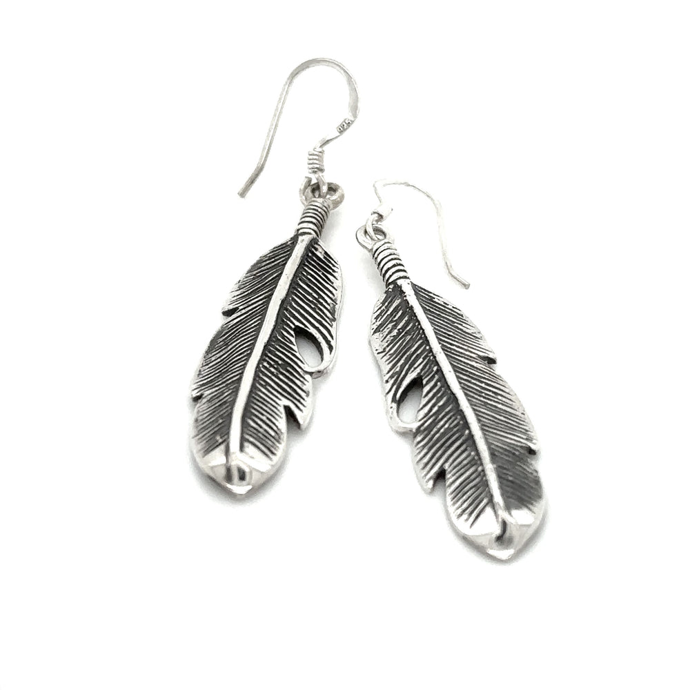 
                  
                    A pair of Super Silver Medium Feather Earrings, a timeless gift for loved ones, showcased beautifully on a white background.
                  
                