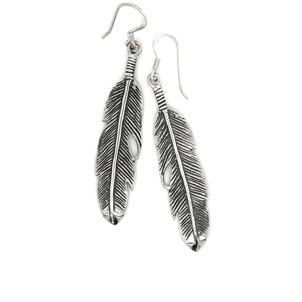 A pair of Super Silver Medium Feather Earrings, a perfect gift for loved ones, displayed on a white background.