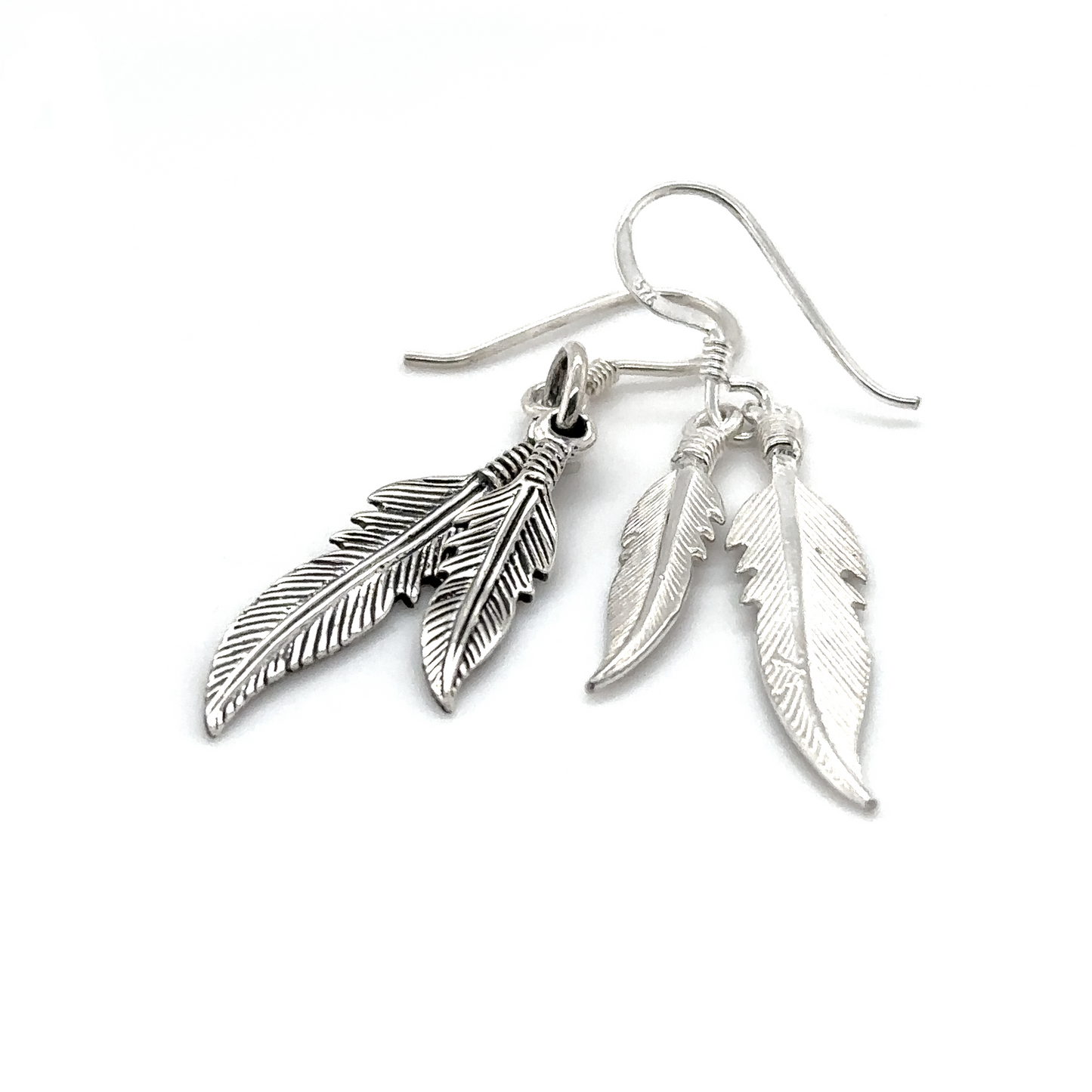 
                  
                    A pair of Super Silver Double Feather Earrings on a white background featuring French hook.
                  
                
