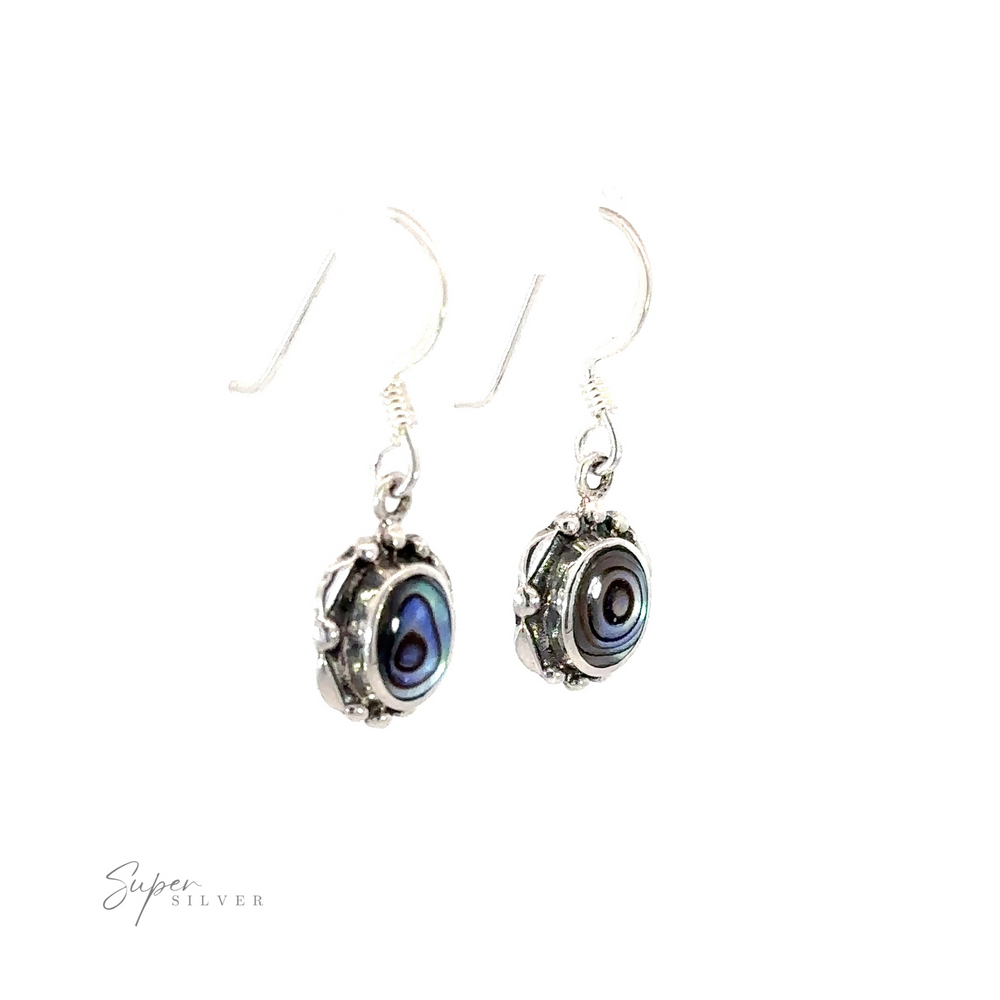 
                  
                    A pair of Oval Inlaid Stone Earrings with a blue and silver design.
                  
                