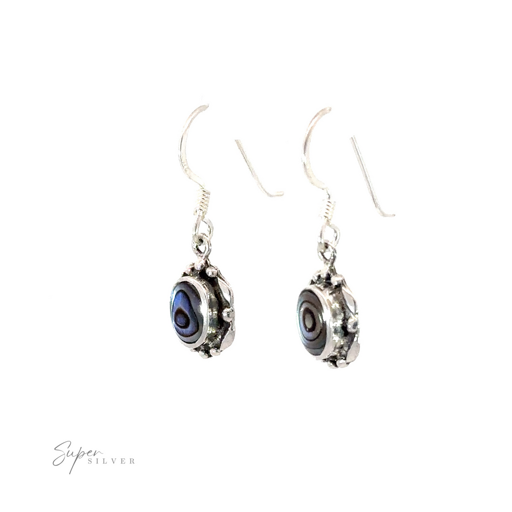 
                  
                    Oval Inlaid Stone Earrings adorned with blue and silver inlaid stone beads.
                  
                