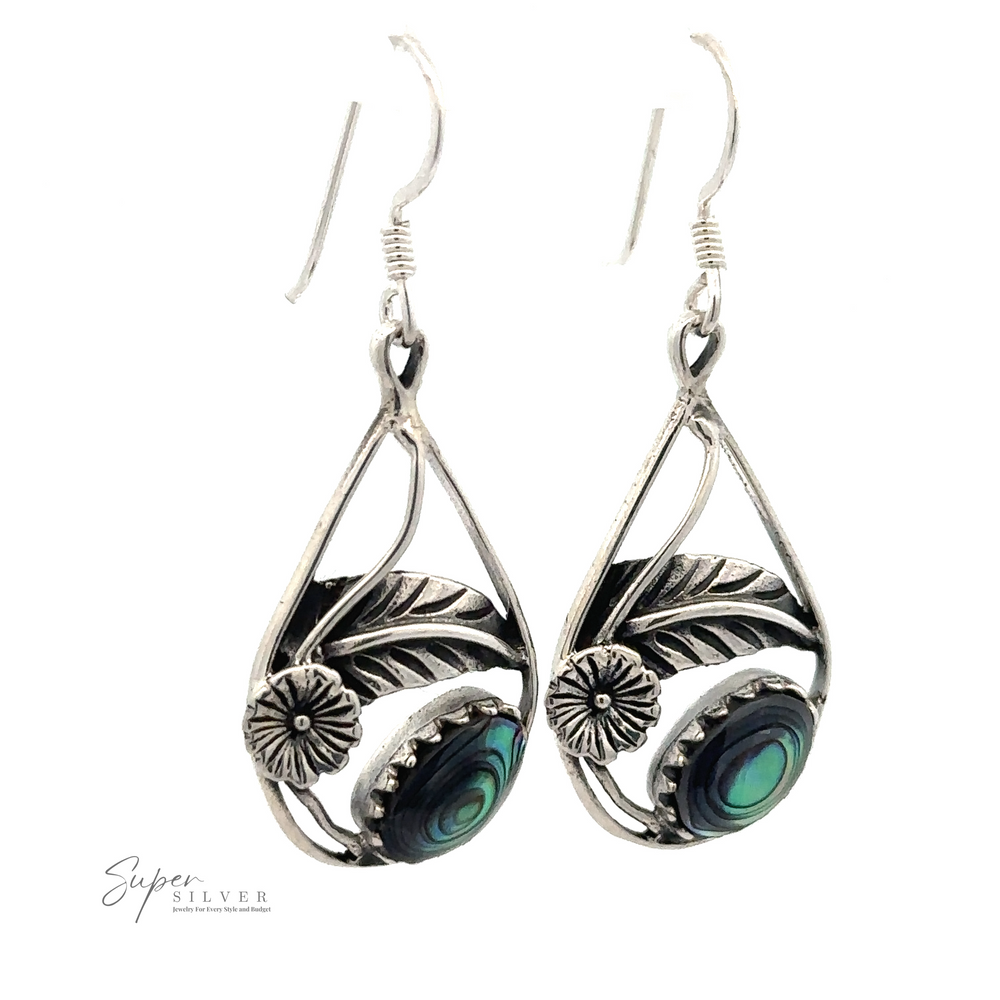 
                  
                    A pair of Inlaid Teardrop Earrings With Floral Setting featuring intricate leaf and flower designs with small green and blue stone accents.
                  
                