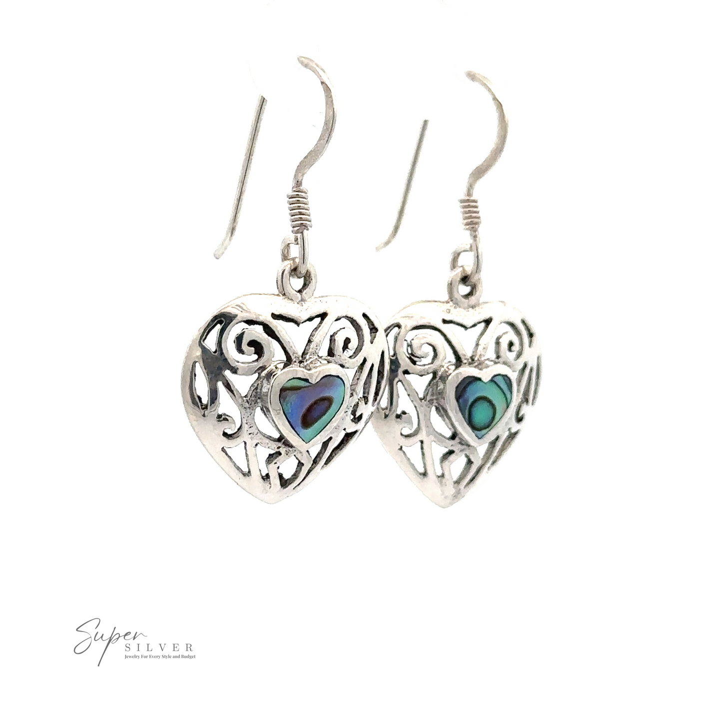
                  
                    A pair of Elegant Heart Shaped Abalone Earrings with intricate cut-out designs and colorful inlays hang from hooks against a white background. "Super Silver" branding is visible in the bottom left corner.
                  
                