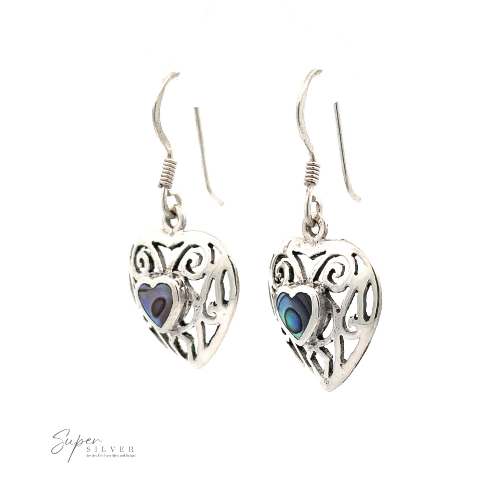 
                  
                    A pair of Elegant Heart Shaped Abalone Earrings with intricate designs and small colorful accents in the center. "Super Silver" logo in the bottom left corner.
                  
                