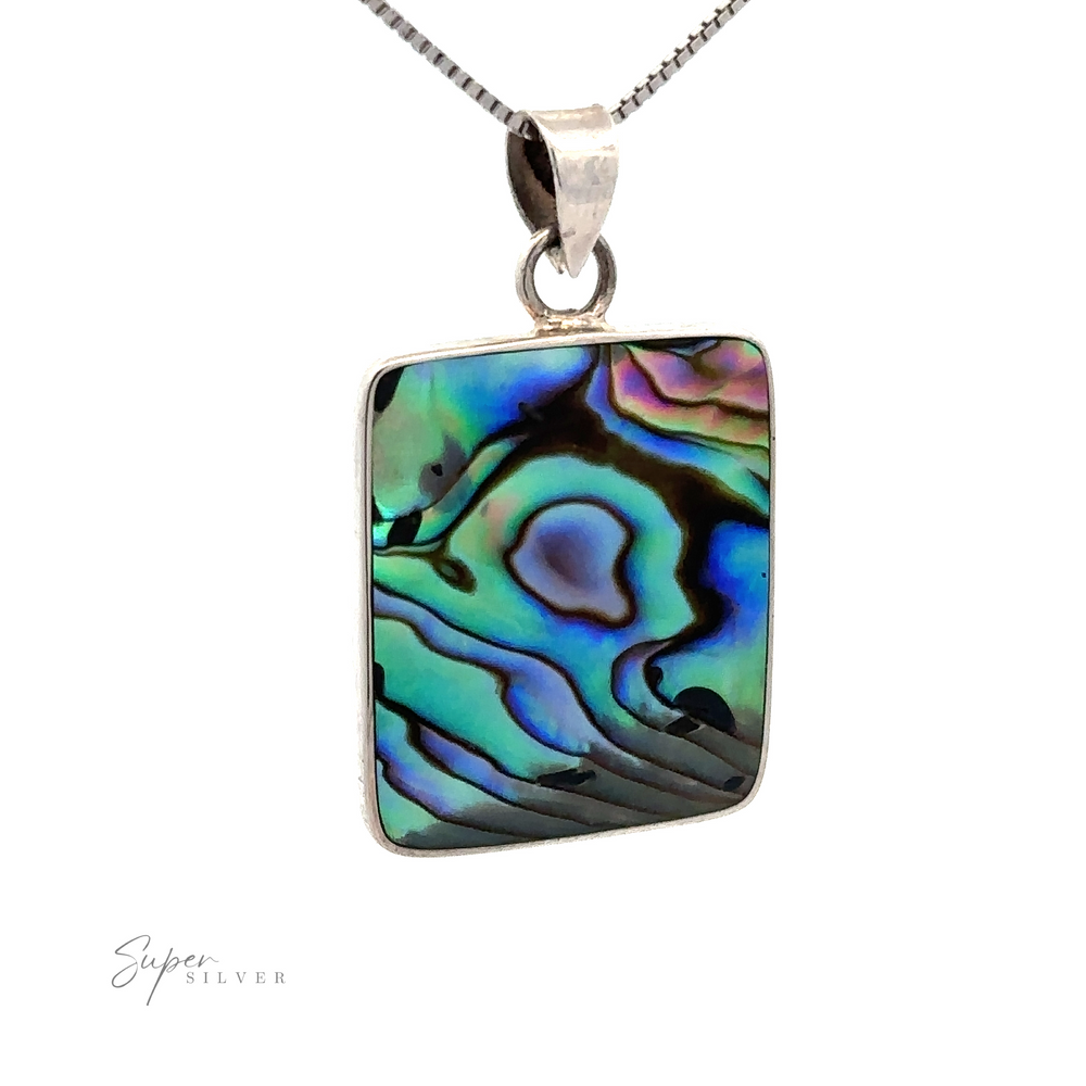 Square abalone pendant exudes a beachy charm, set in a sterling silver frame and chain, and showcases iridescent swirls of green, blue, and purple.