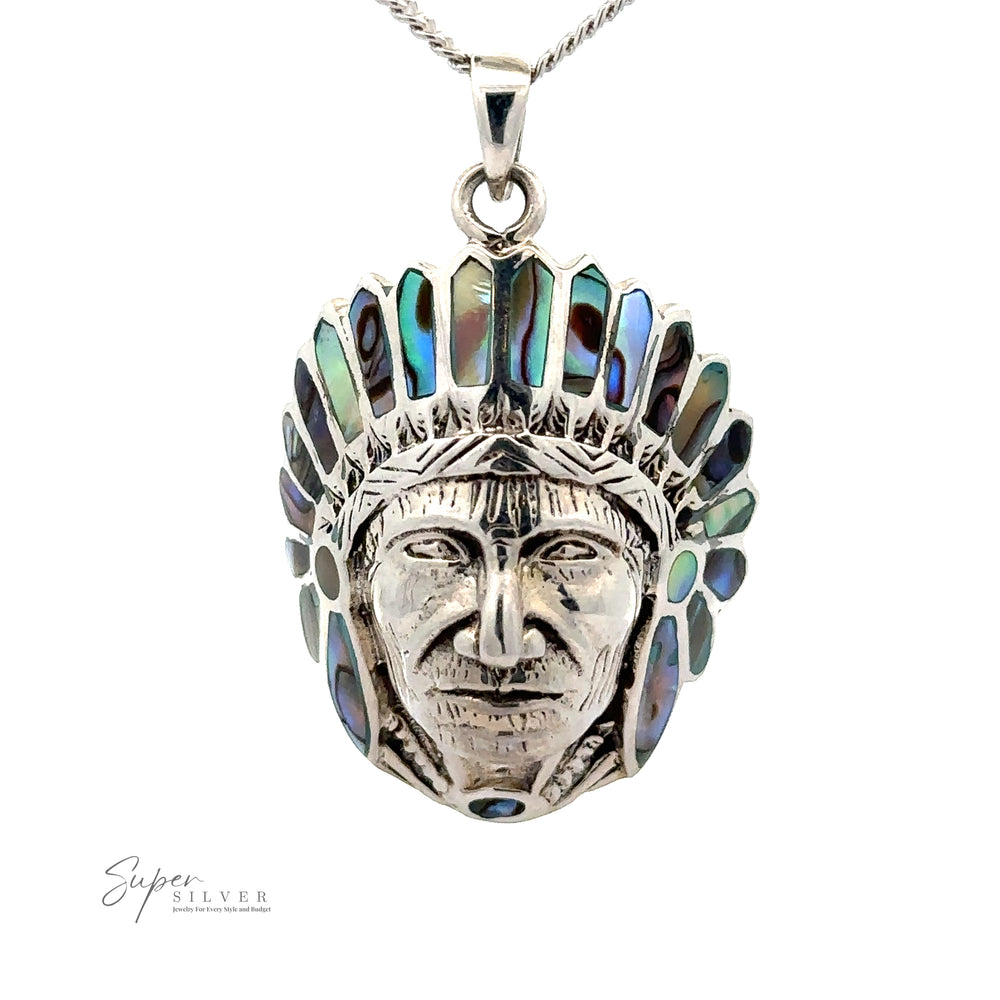 
                  
                    A Chief Pendant With Inlaid Stones featuring a detailed head of a Native American chief adorned with colorful inlaid stones.
                  
                