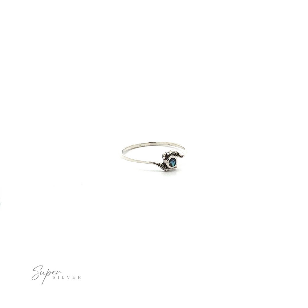
                  
                    Tiny Freeform Ring with a Round Turquoise Stone on a white background.
                  
                