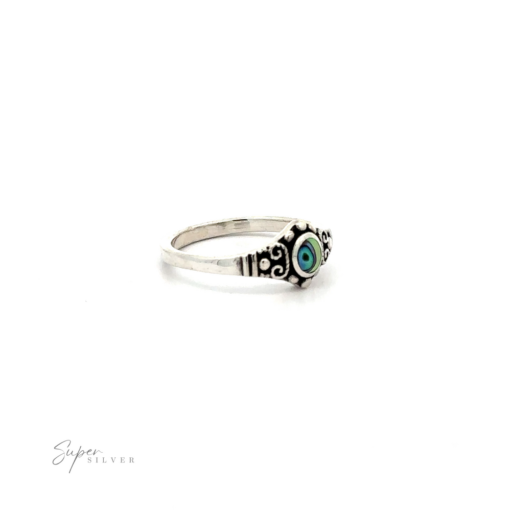 
                  
                    A Dainty Inlaid Stone Ring With Silver Beads and Swirls silver ring with an inlaid blue stone.
                  
                