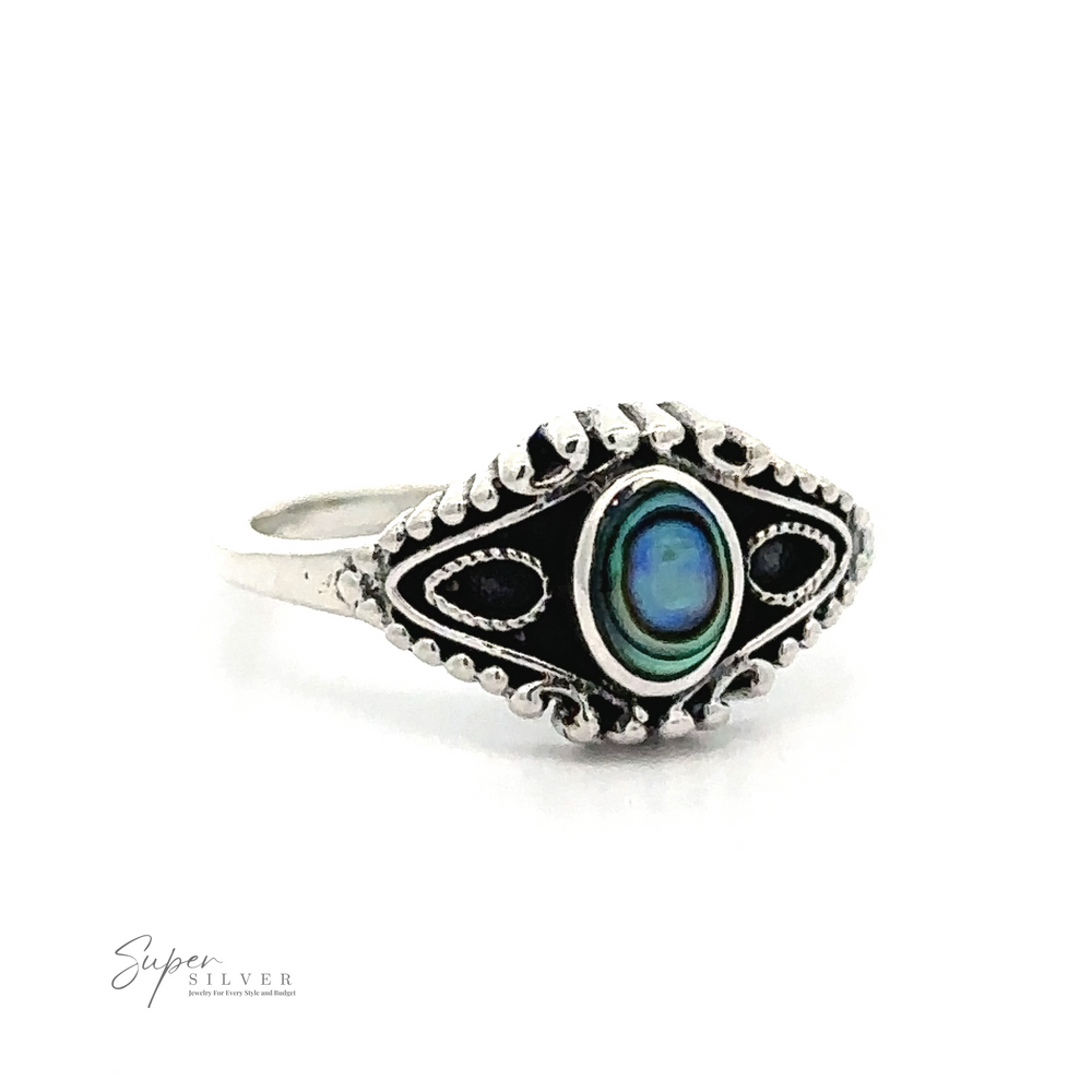 
                  
                    A Vintage Style Ring With Inlaid Oval Stone crafted from .925 Sterling Silver, featuring an intricate design with an inlaid blue-green stone at the center and detailed patterns surrounding it. The inscription "Super Silver" is visible on the lower left of the image.
                  
                