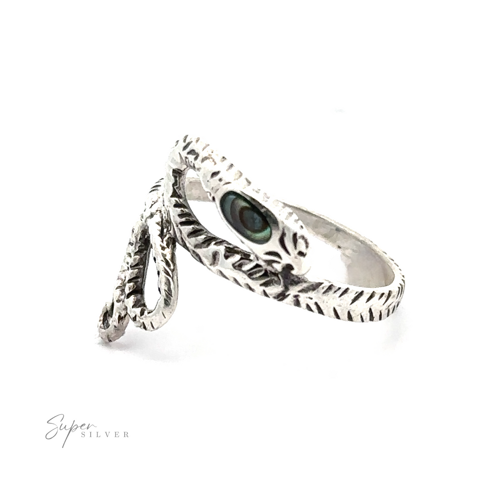 
                  
                    Inlay Stone Snake Ring showcasing a textured sterling silver band with a vibrant green stone eye, presented on a plain white background.
                  
                