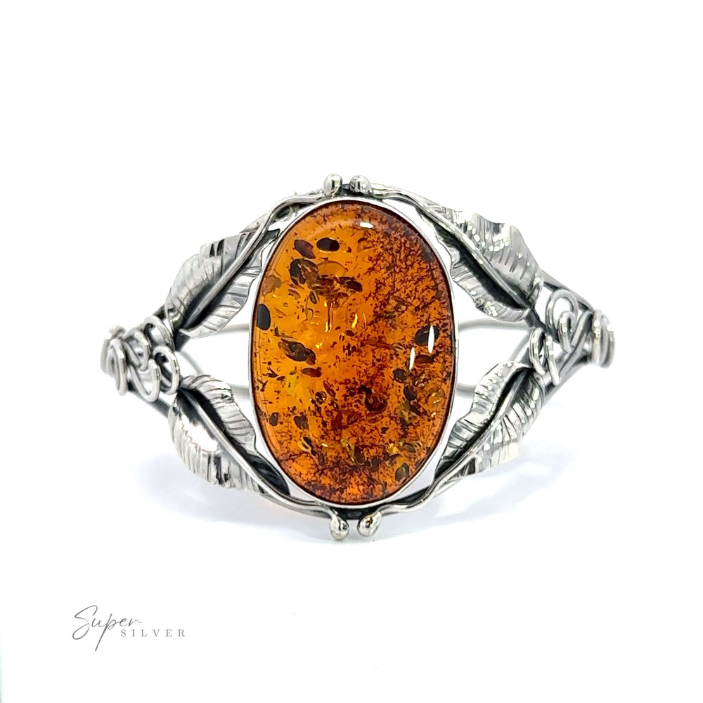 An Exquisite Amber Floral Cuff featuring a large amber stone.