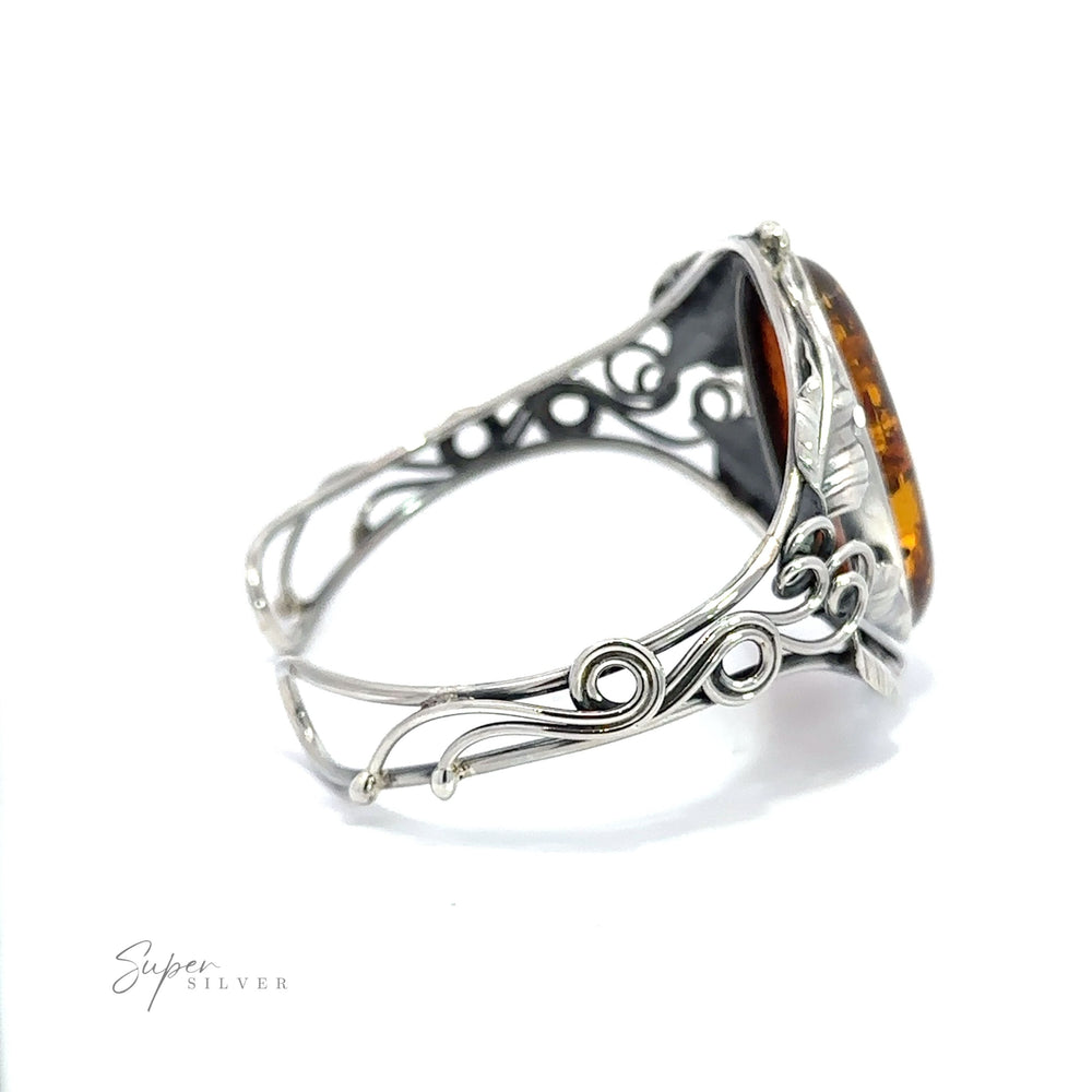 
                  
                    A contemporary design silver ring with the Exquisite Amber Floral Cuff.
                  
                