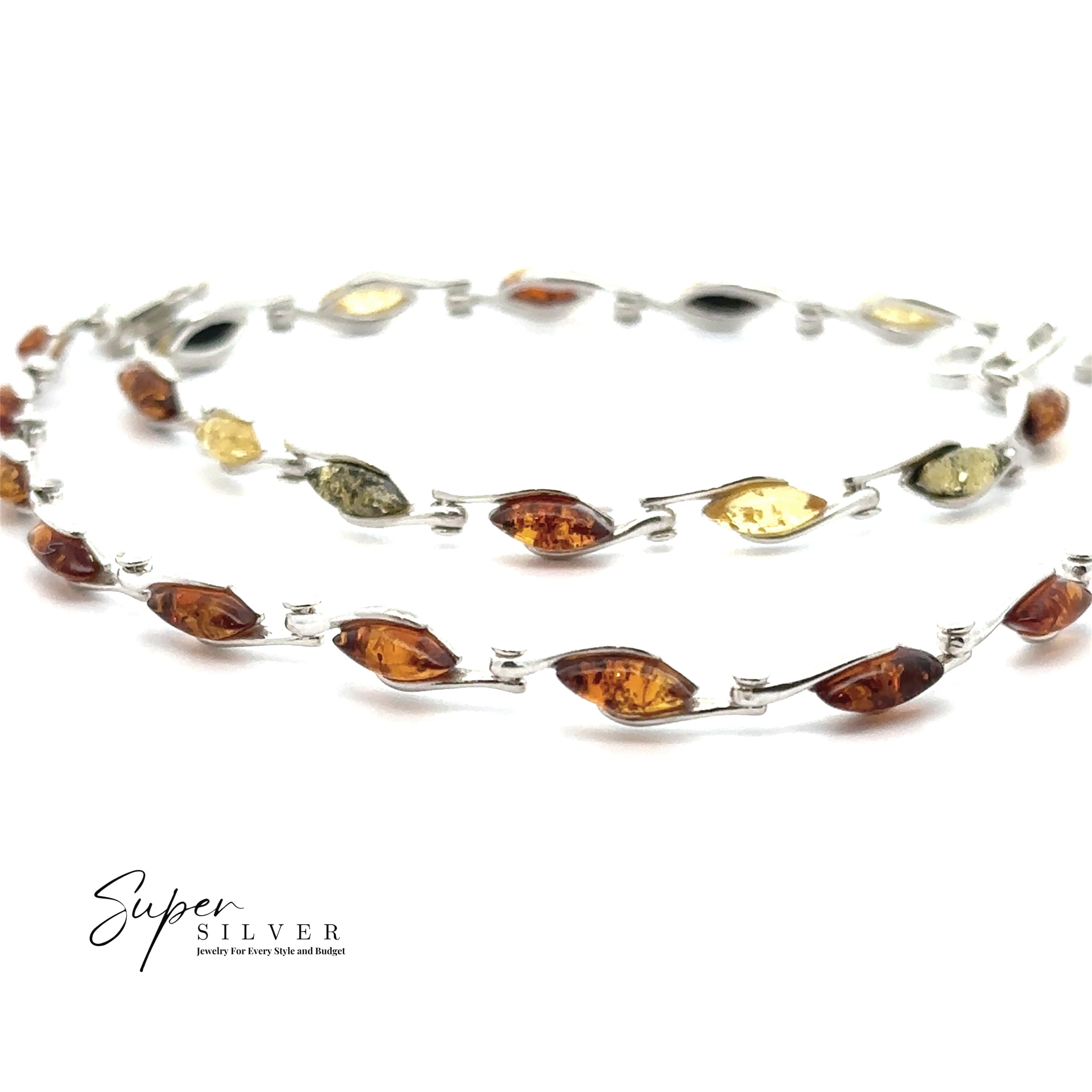 The Baltic Amber Marquise Bracelet features alternating marquise-shaped amber stones in cognac, yellow, and green hues set in sterling silver, displayed on a white background.