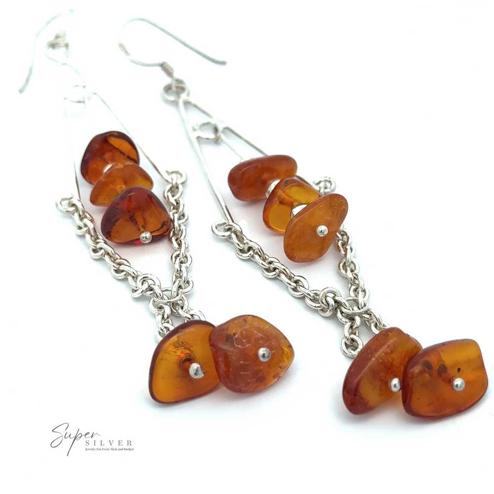 
                  
                    A pair of Beaded Amber Tassel Earrings featuring amber-colored stones and silver chains, observed against a white background with the Super Silver logo in the corner, perfect for festival fashion.
                  
                
