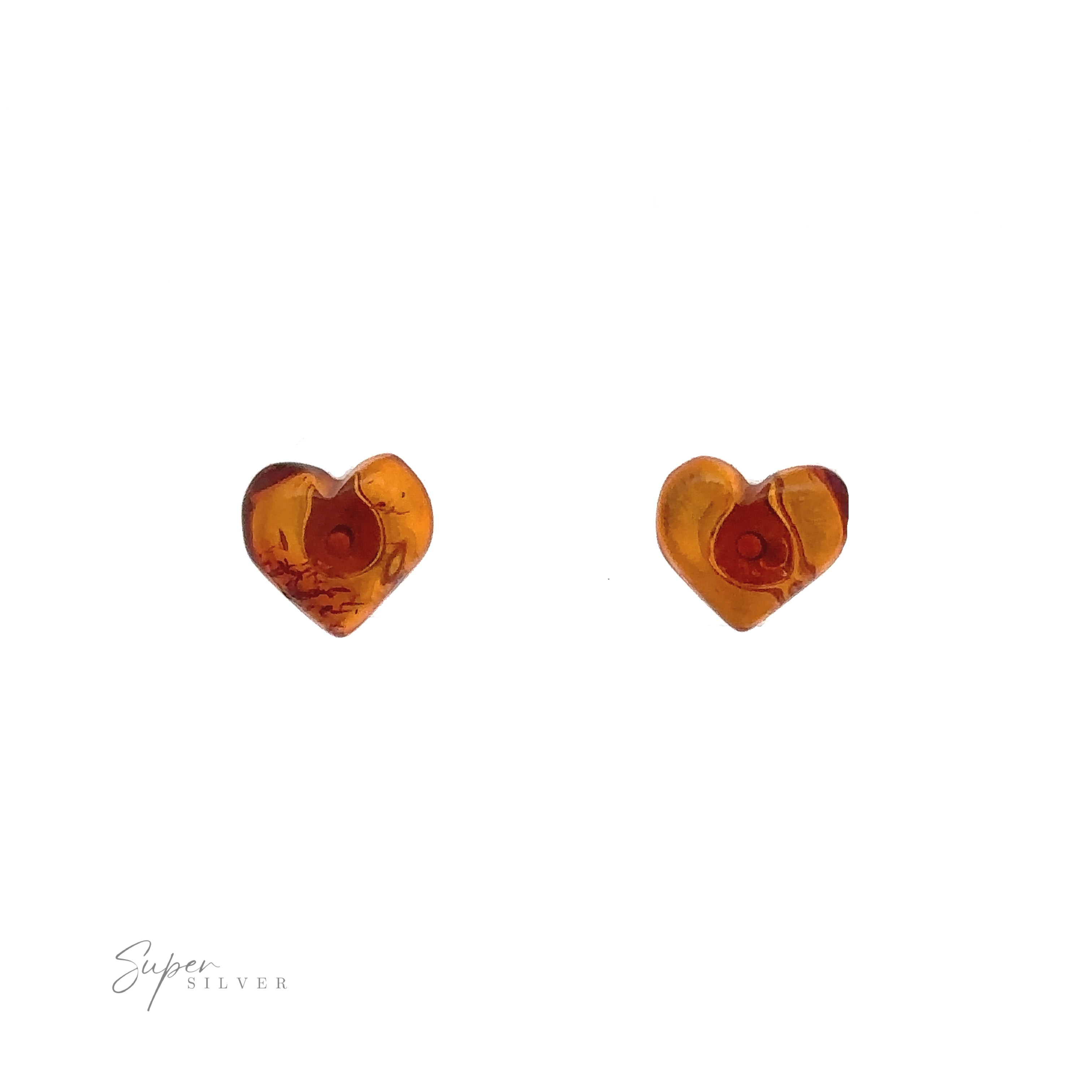 A pair of heart-shaped amber-colored earrings against a white background with "Super Silver" text in the bottom left corner. These stunning Amber Heart Studs exemplify exquisite craftsmanship, perfect for any fashion-forward enthusiast.