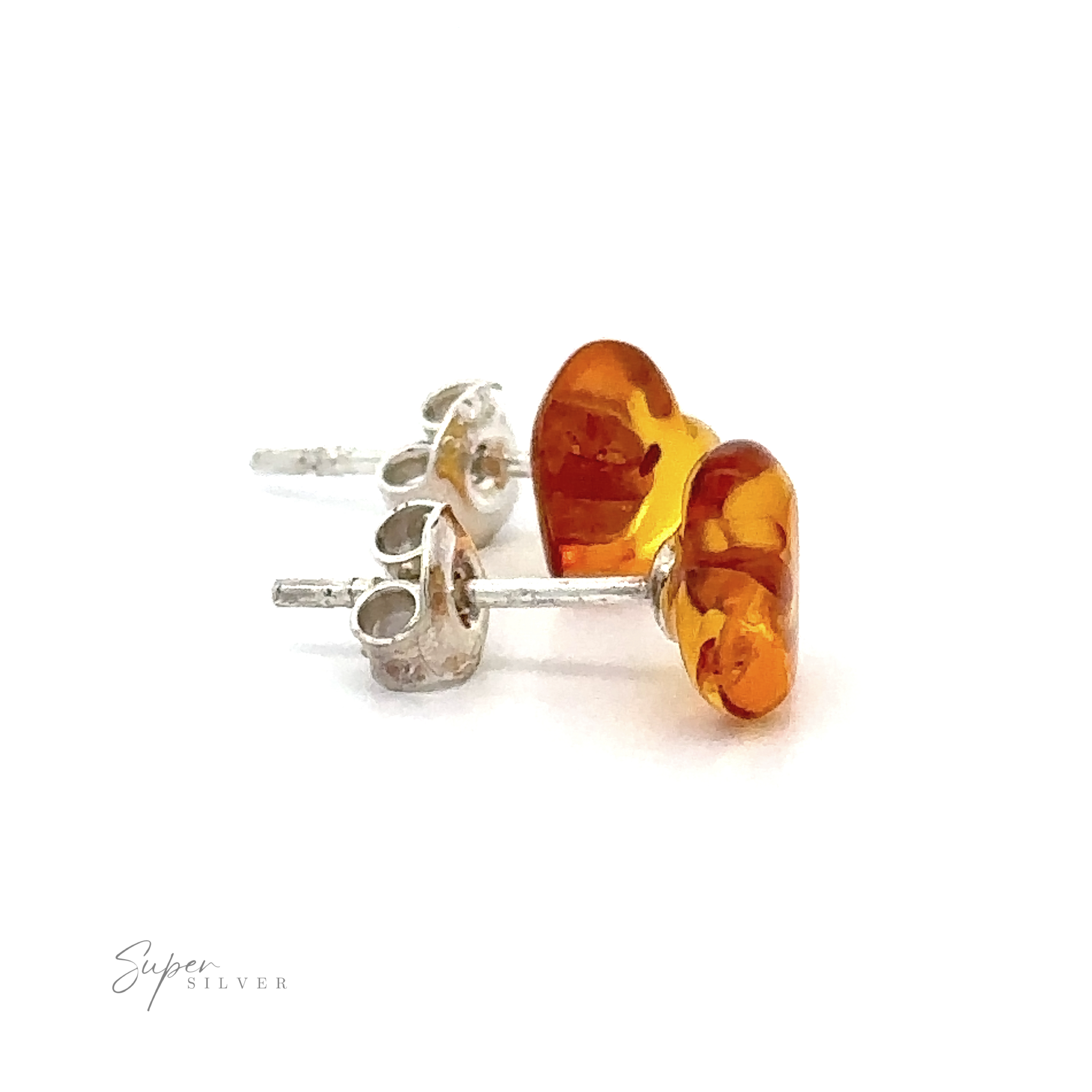 Close-up of a pair of Amber Heart Studs with amber-colored, heart-shaped stones against a white background.