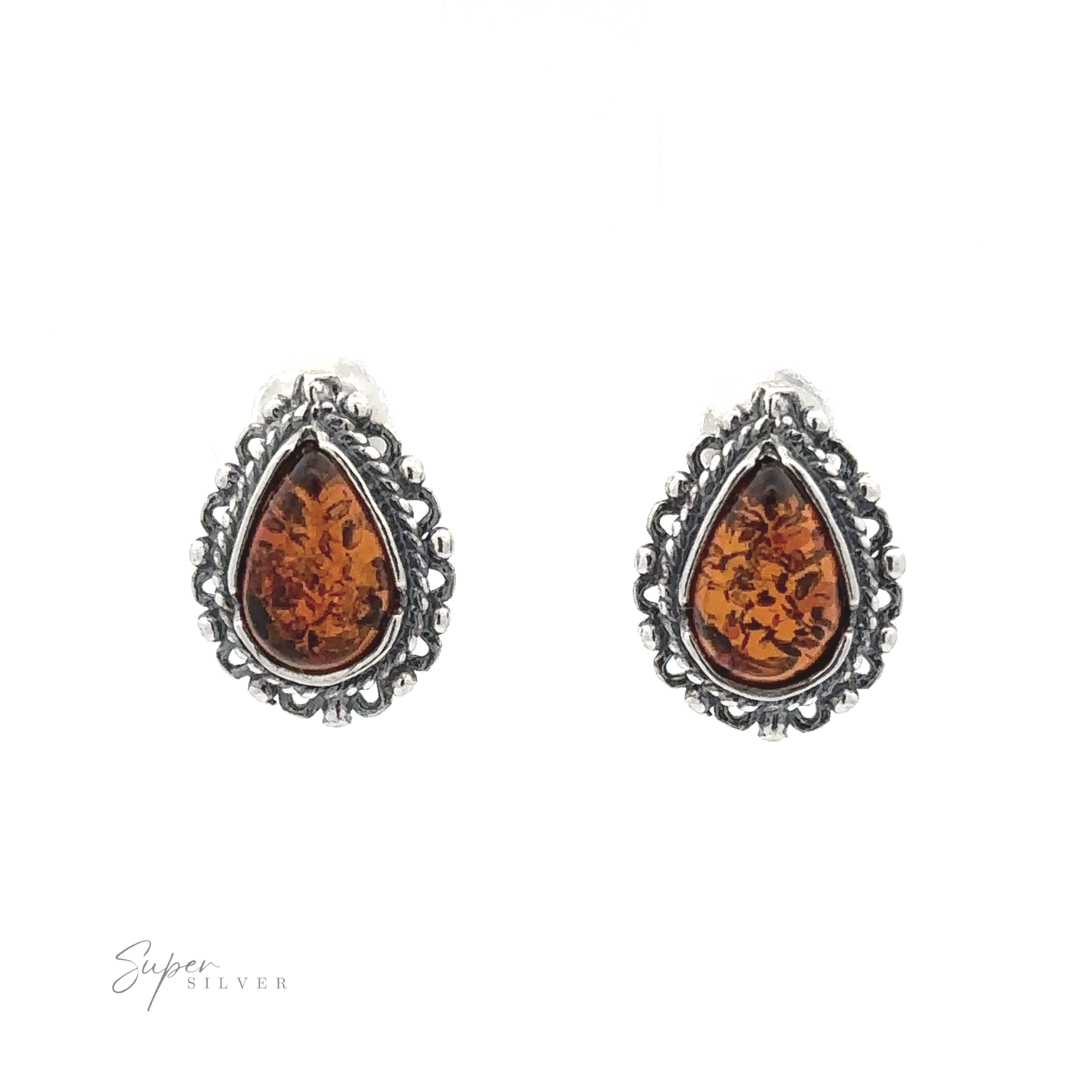 A pair of Framed Teardrop Amber Studs set in ornate silver settings, displayed on a white background with the "Super Silver" logo at the bottom left corner, exuding a sense of vintage romance.