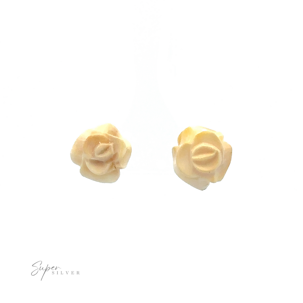 
                  
                    Image of two small, beige rose-shaped earrings on a white background with the text "Super Silver" in the bottom left corner. These elegant pieces are reminiscent of Butterscotch Amber Rose Studs, crafted with sterling silver.
                  
                