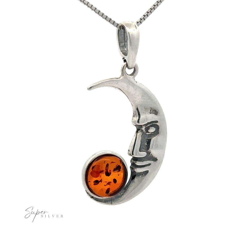 Baltic Amber Man in the Moon Pendant featuring a face, adorned with a cognac Baltic amber gemstone at the tip, hanging on a sleek silver chain.