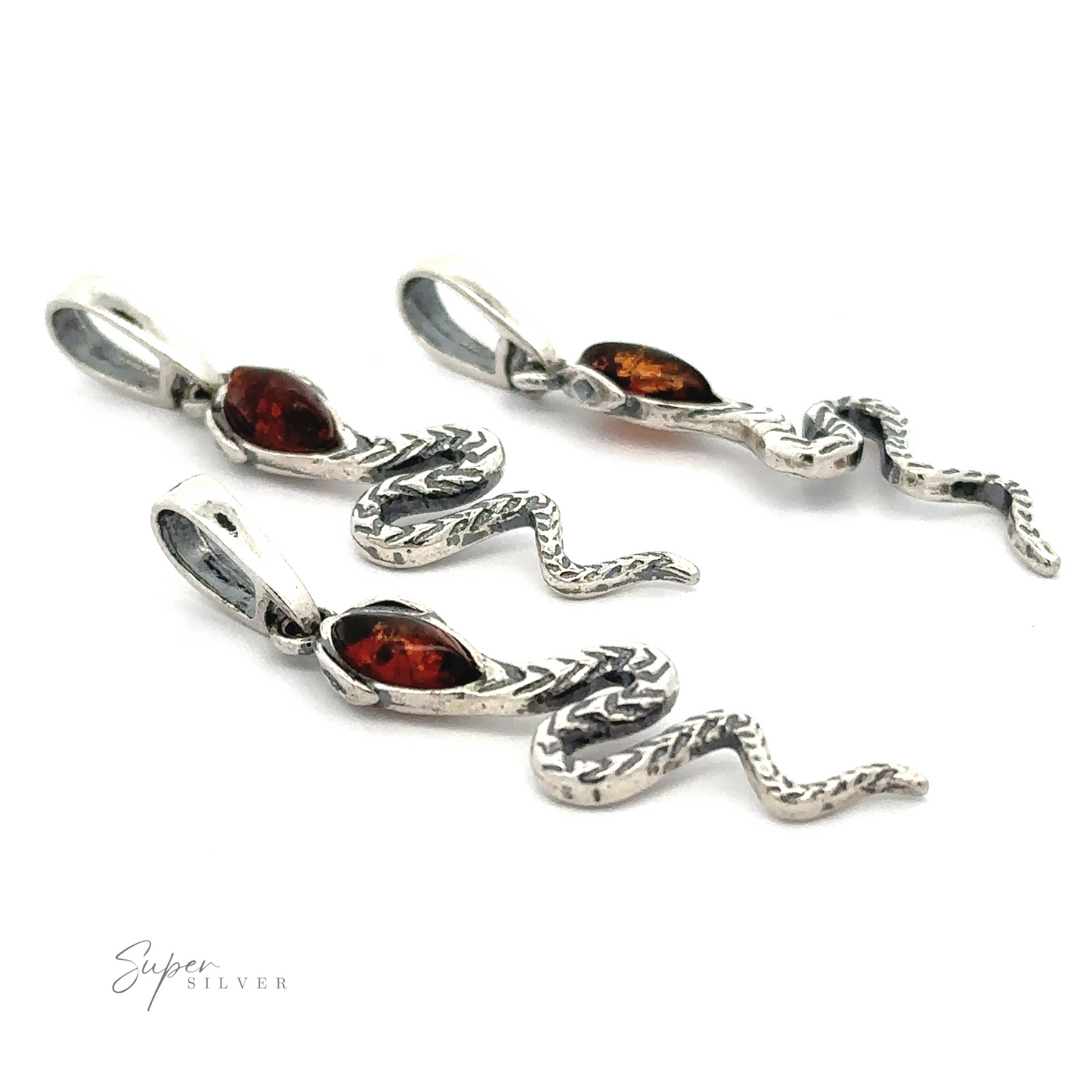 Three Alluring Amber Snake Pendants with Baltic amber stones and intricate detailing are displayed. Each snake pendant exudes a vintage vibe, complete with loops for attaching to a necklace or bracelet.