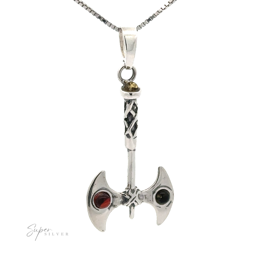 An Amber Accented Battle Axe Pendant with one red and one black gemstone on its blades, hanging from a silver chain, symbolizing courage and good fortune.