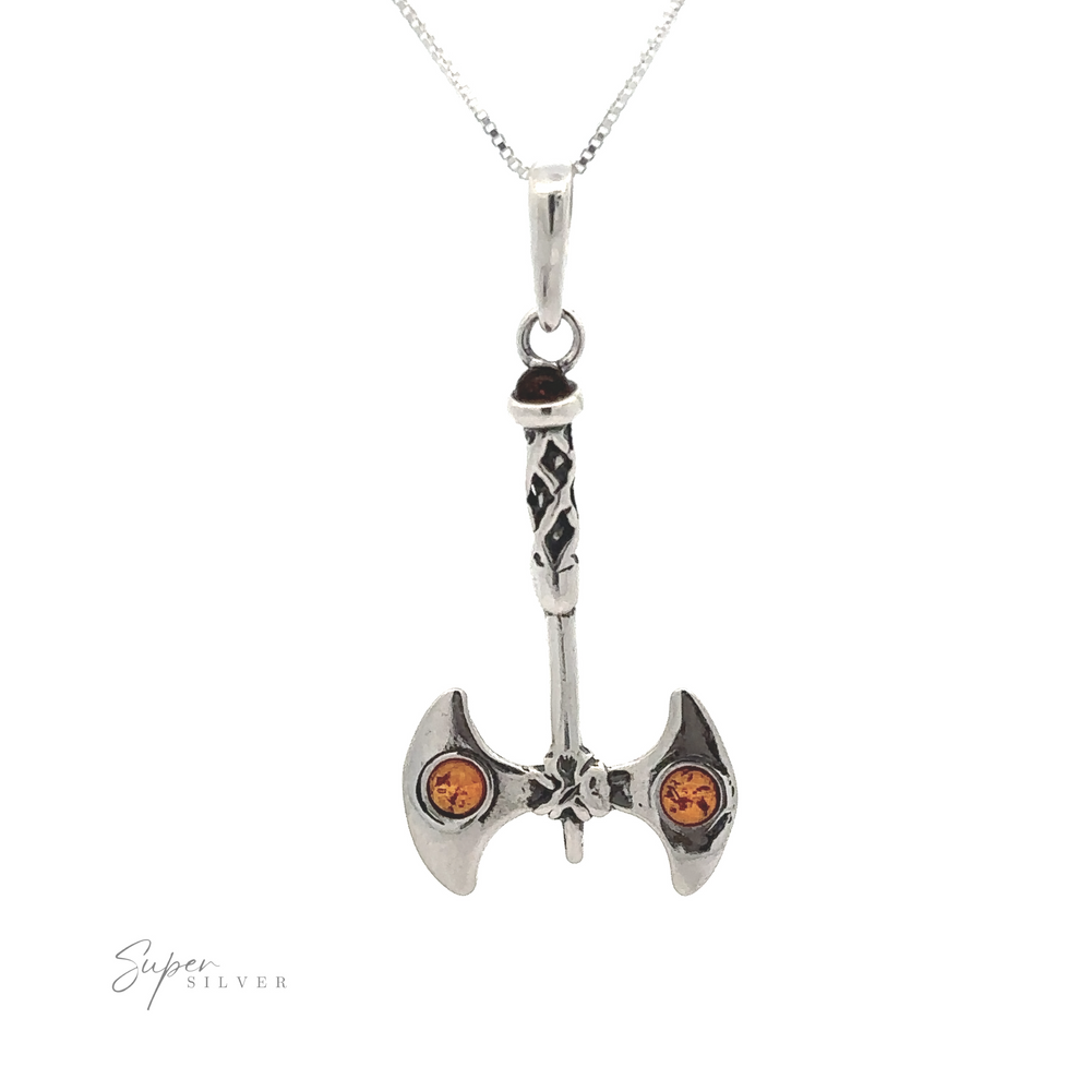 An Amber Accented Battle Axe Pendant with intricate designs and two orange gemstones, suspended on a chain like a warrior necklace. The word "Super Silver" is visible in the lower left corner.