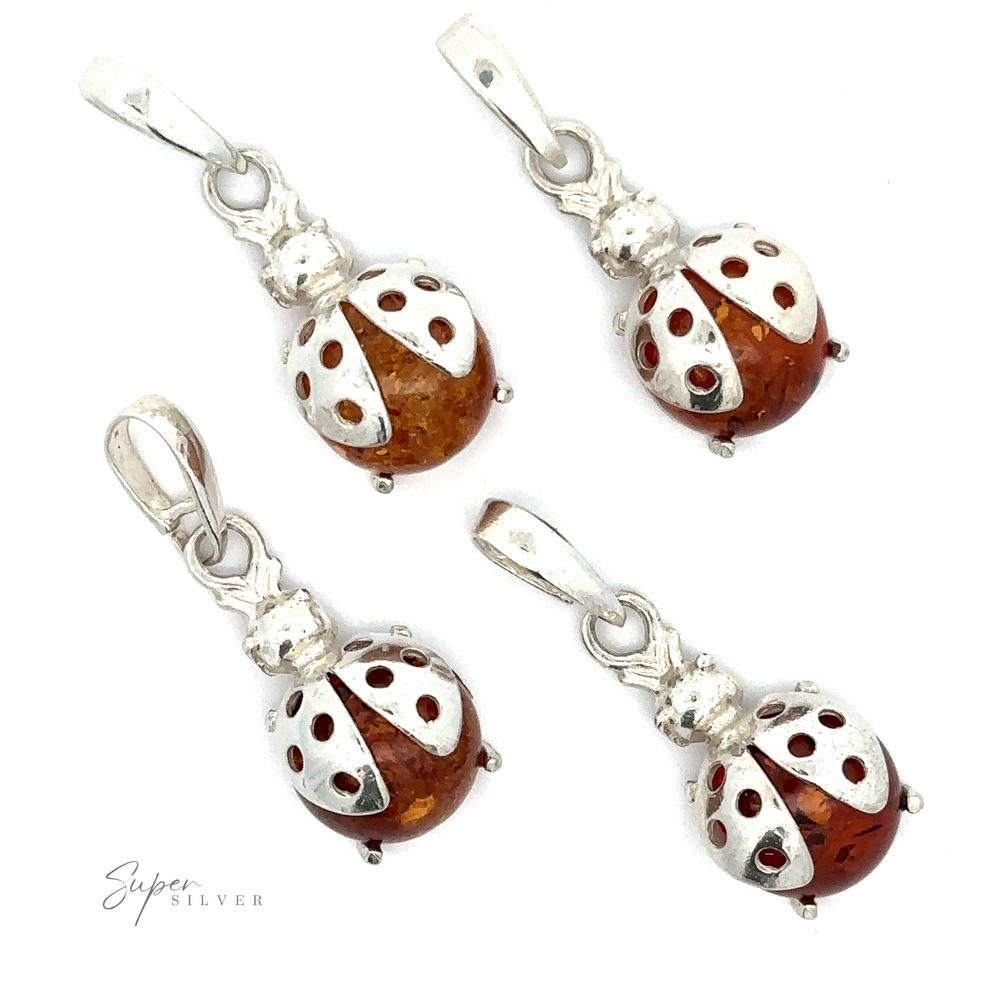 Four Amber Ladybug Pendants are arranged on a white background, displaying intricate detailing.
