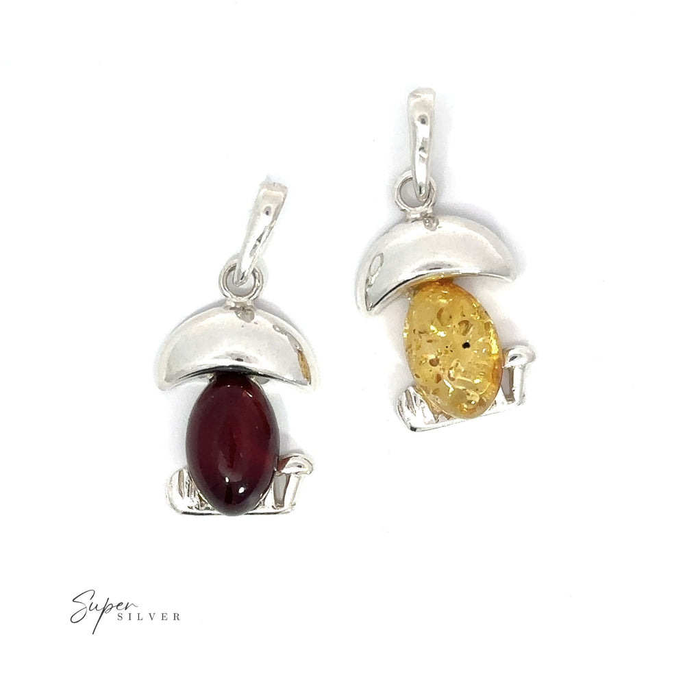 Two funky silver charms featuring a red and yellow Amber Mushroom Pendant and a green Amber Mushroom Pendant, inspired by Mother Nature's charm.