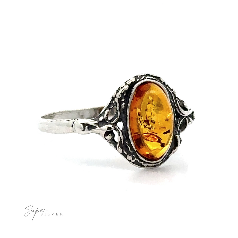 
                  
                    Delicate Baltic Amber Ring with Antique Setting featuring an oval-shaped cognac amber stone set in an intricately designed band, displayed against a white background.
                  
                