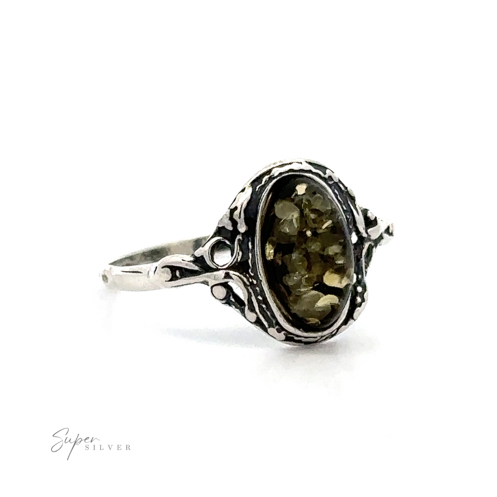
                  
                    Delicate Baltic Amber Ring with Antique Setting with an oval, faceted cognac amber gemstone in a detailed filigree setting, displayed against a white background.
                  
                