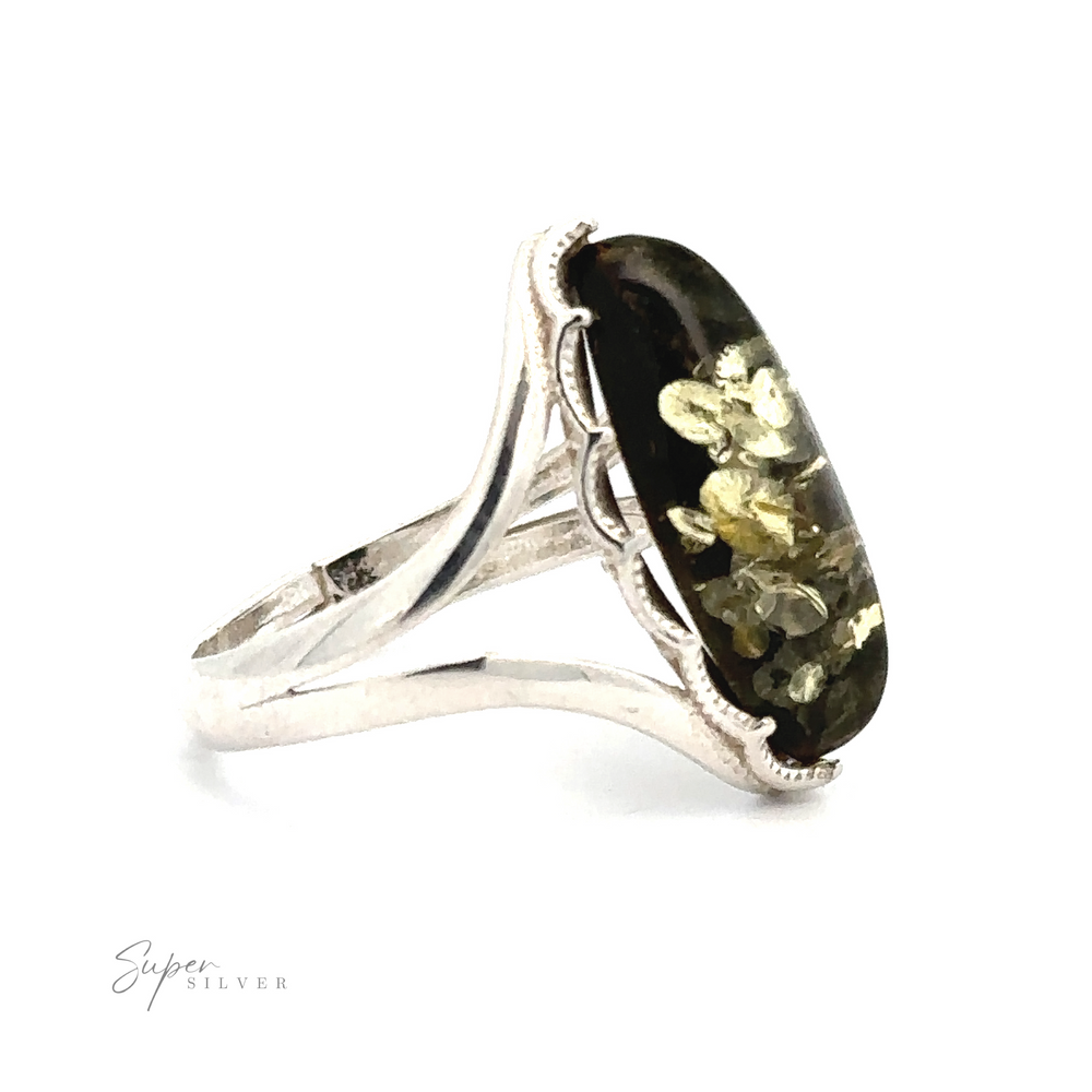 
                  
                    A Marquise-Shaped Baltic Amber Adjustable Ring featuring an oval black stone with gold-colored floral patterns, displayed against a white background. The ring band has a split shank design and the word "Super Silver" is inscribed. This elegant piece is reminiscent of an amber ring, capturing timeless beauty.
                  
                