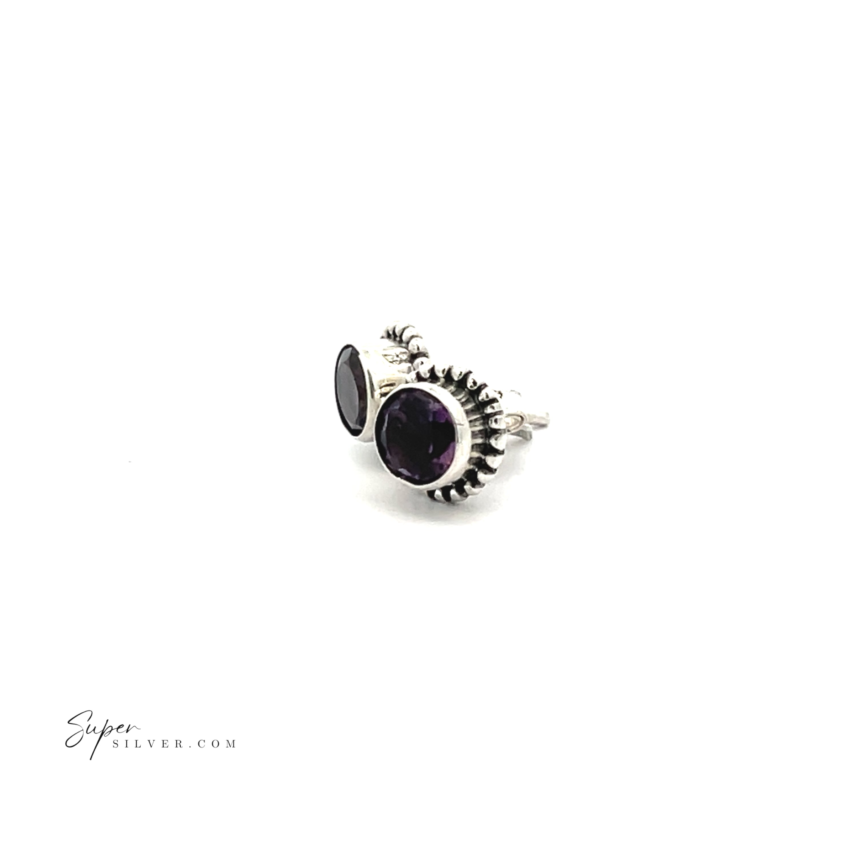 Beaded Round Faceted Gemstone Studs in sterling silver feature two dark purple faceted gemstones, one large and one small, set in decorative bezels. Shown on a white background.