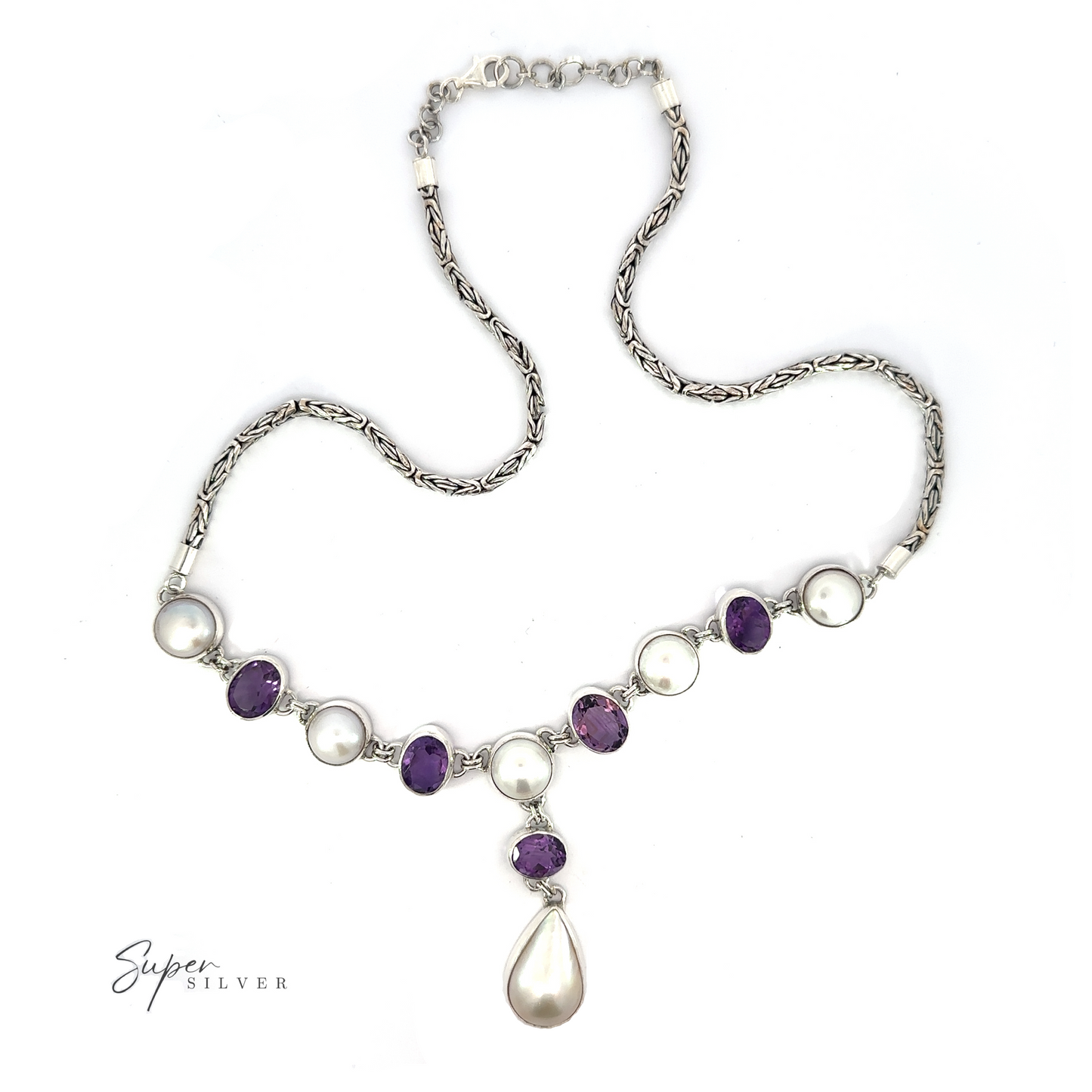 
                  
                    A Stunning Pearl and Gemstone Statement Necklace featuring alternating purple and white gemstones and pearls, with a teardrop-shaped pearl pendant at the center.
                  
                
