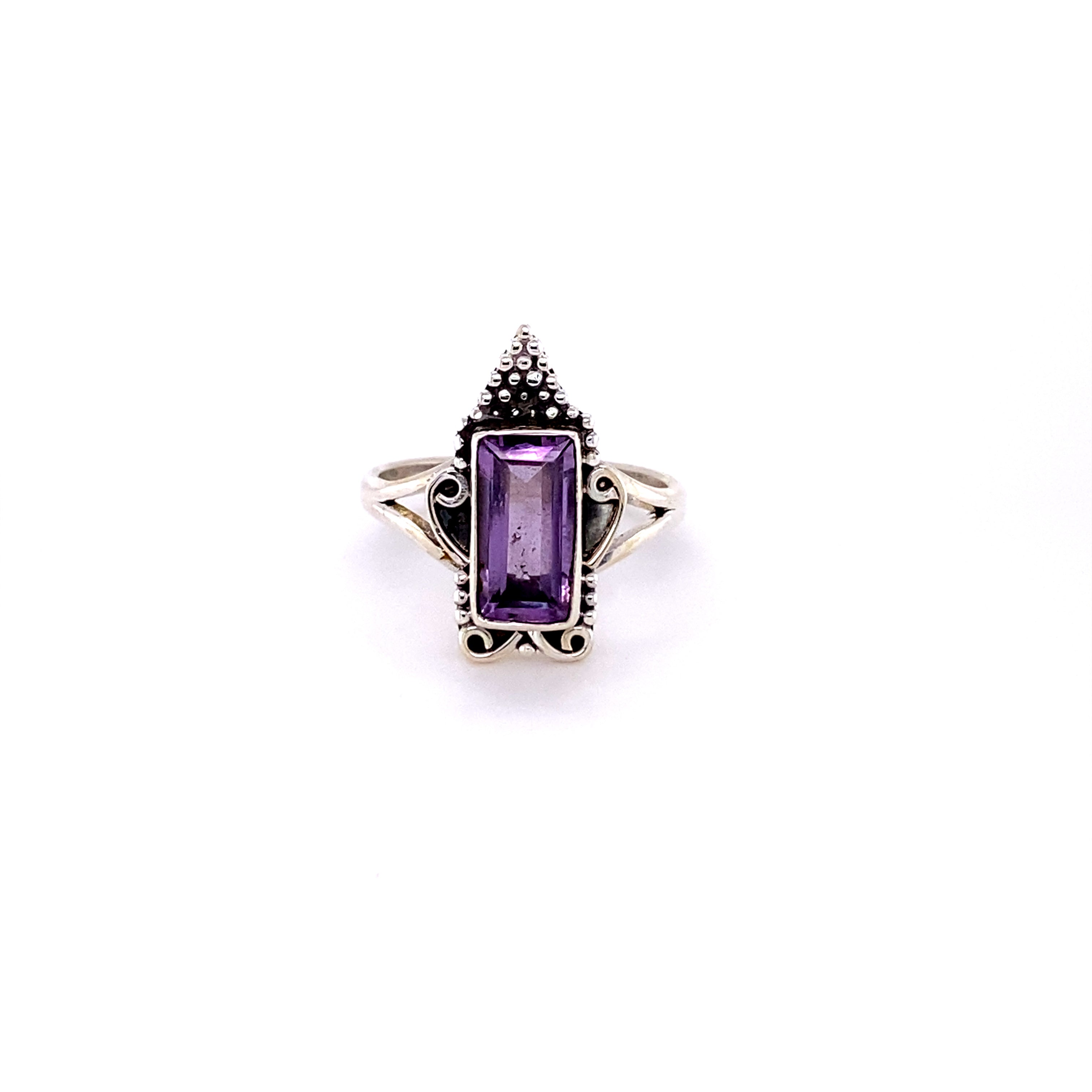 A silver, Bohemian Princess Ring with intricate detailing, featuring a rectangular amethyst at its center.