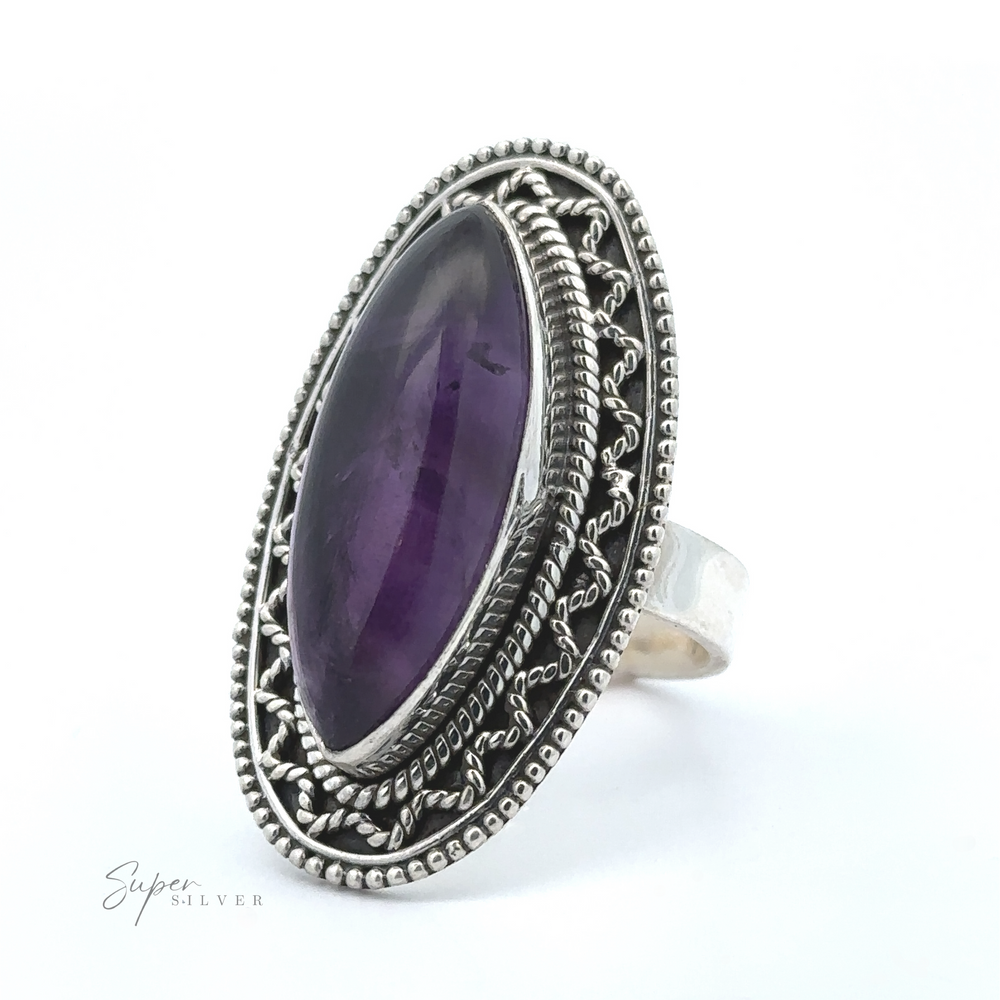 
                  
                    A Marquise Shaped Gemstone Ring With Vintage Shield Border featuring a large marquise-shaped purple gemstone set in an ornate bezel design, offering a bohemian twist with vintage appeal.
                  
                