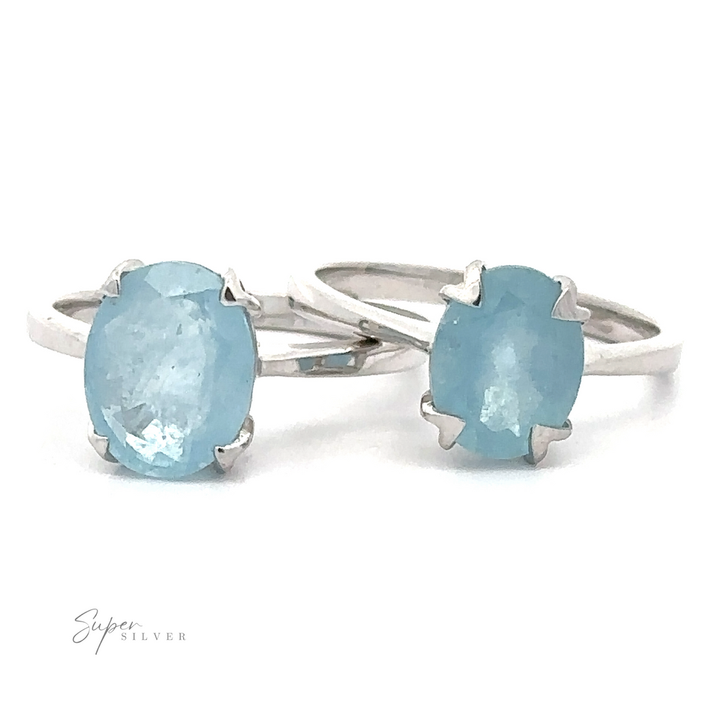Two sterling silver Aquamarine Rings with oval aquamarine gemstones on a white background.