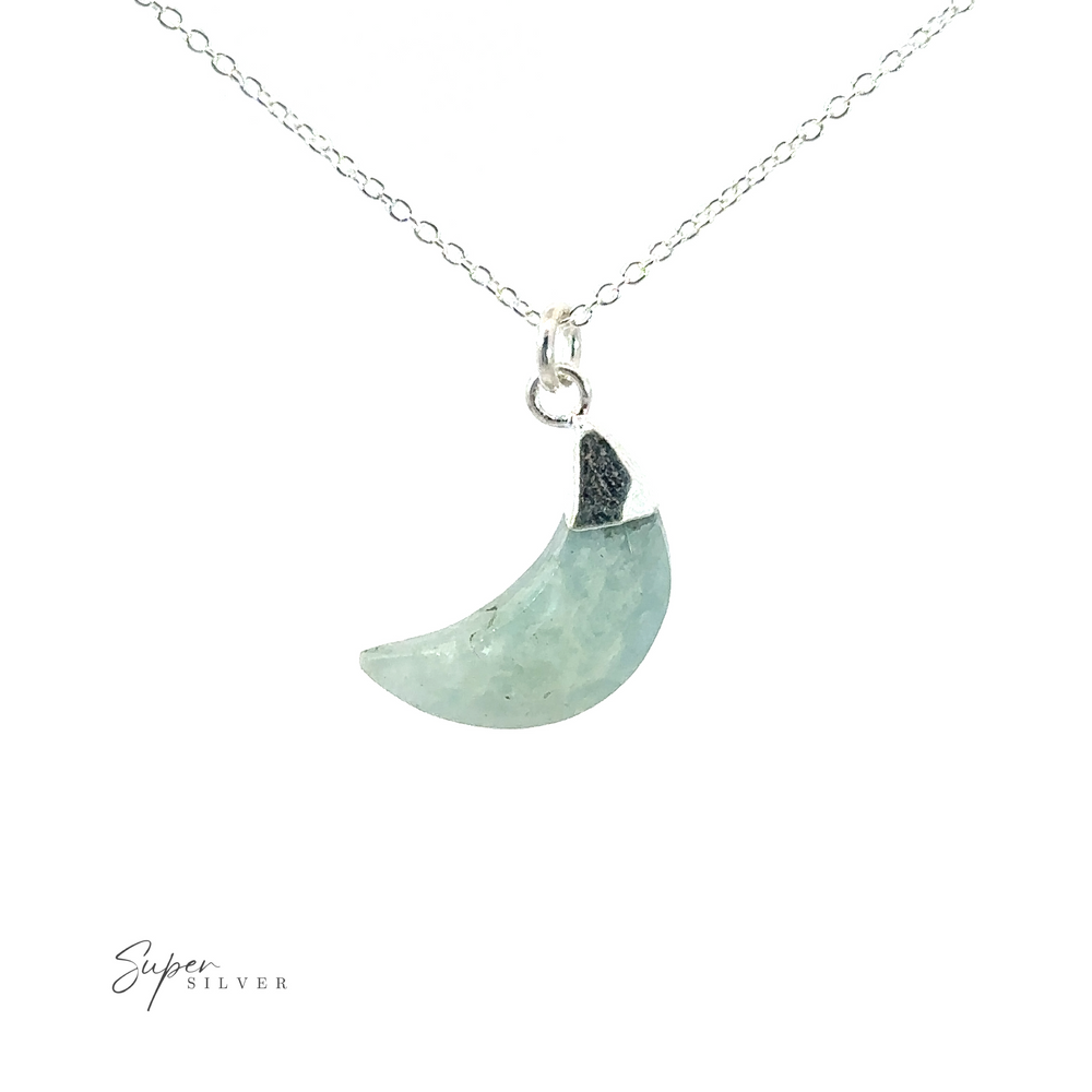 A Delicate Stone Moon Necklace with a crescent moon on it.