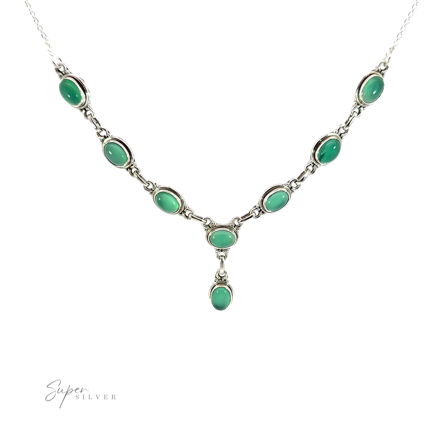 
                  
                    A silver Simple Oval Y Necklace with Gemstones featuring eight green oval gemstones evenly spaced along the chain with a single hanging green oval stone in the center. The "Super Silver" logo is on the bottom left corner, adding a touch of bohemian charm to this elegant piece.
                  
                
